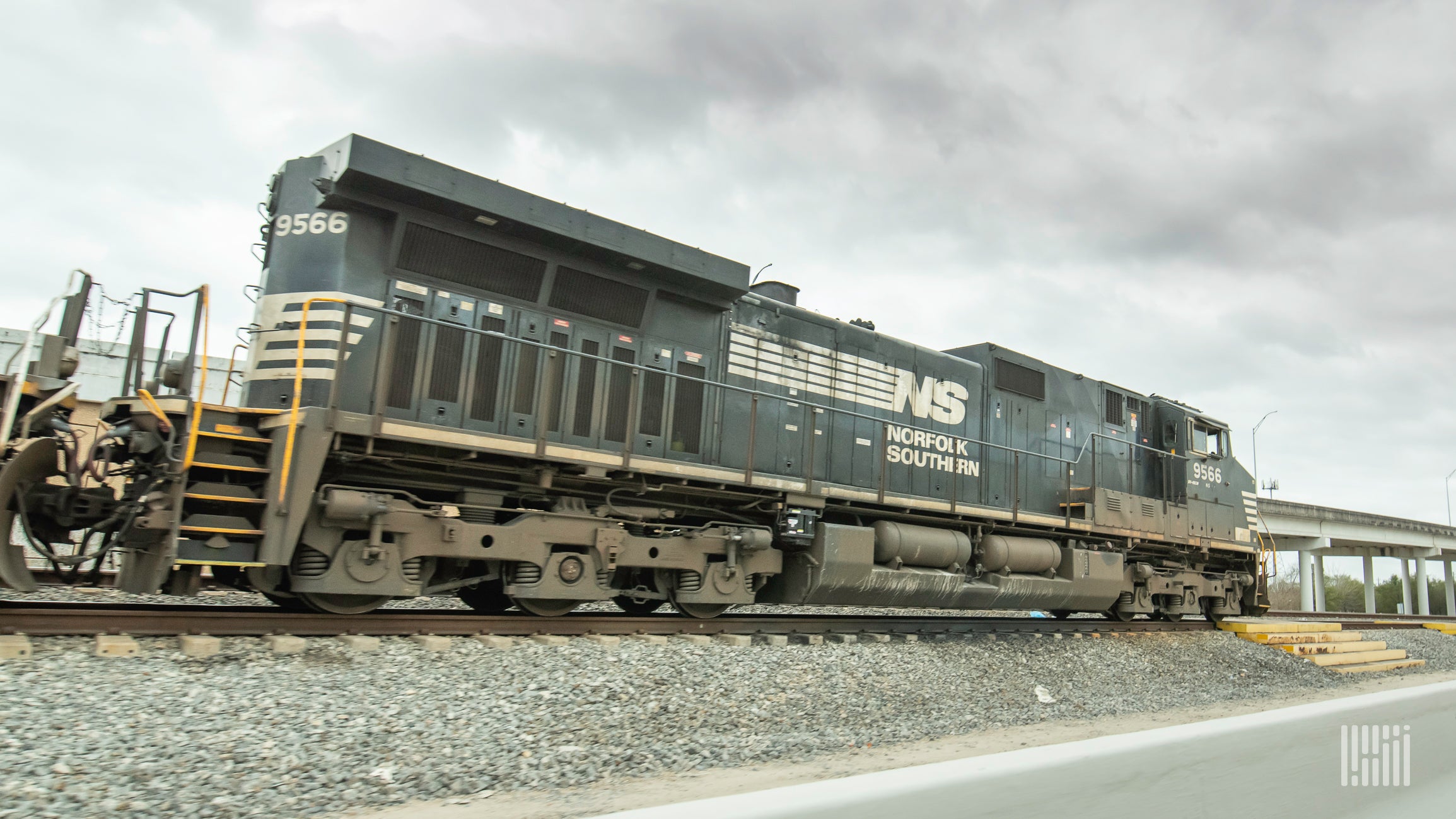 A photograph of a Norfolk Southern locomotive parked in a rail yard.