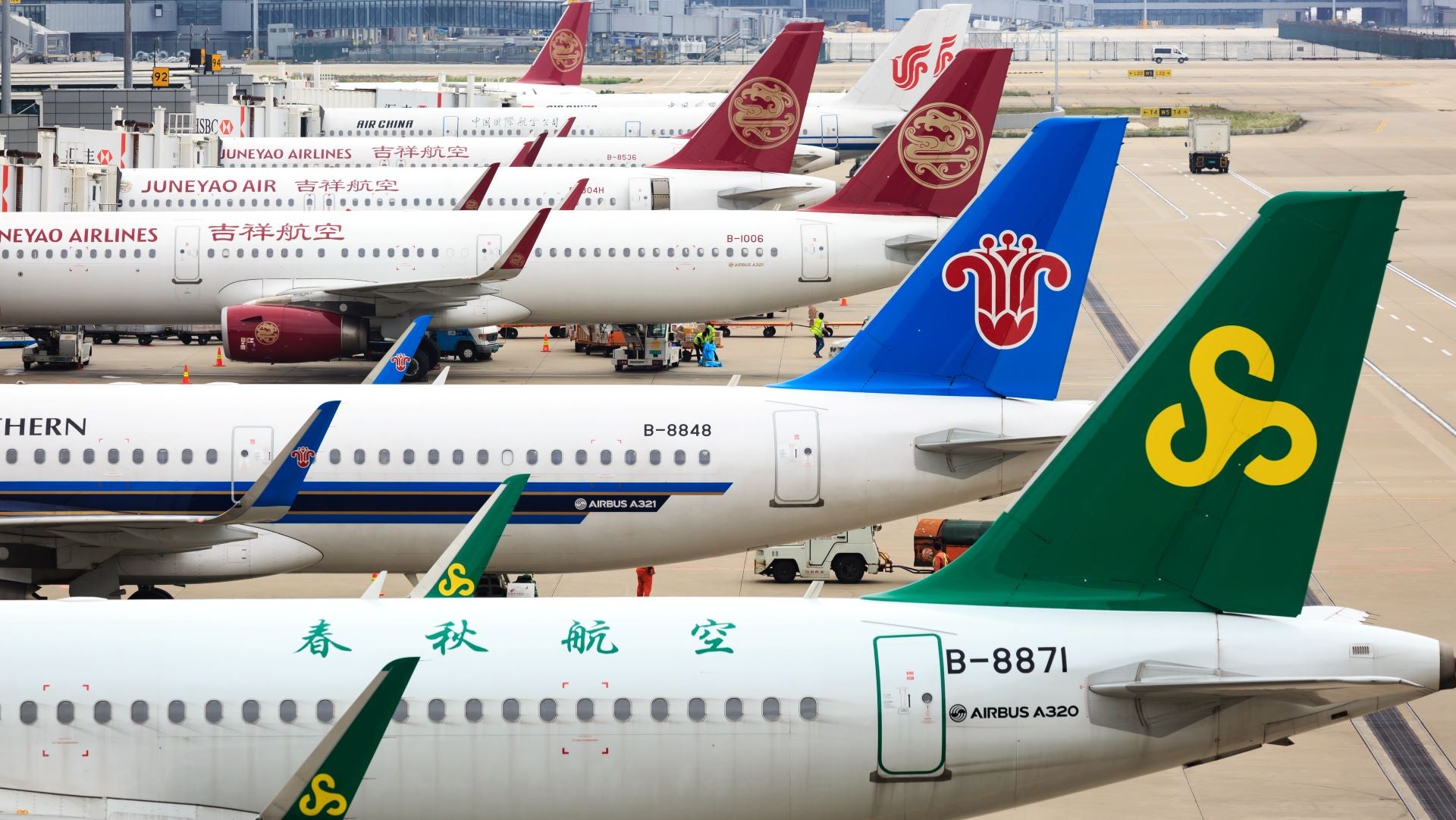 Planes parked at Shanghai Airport in a row.