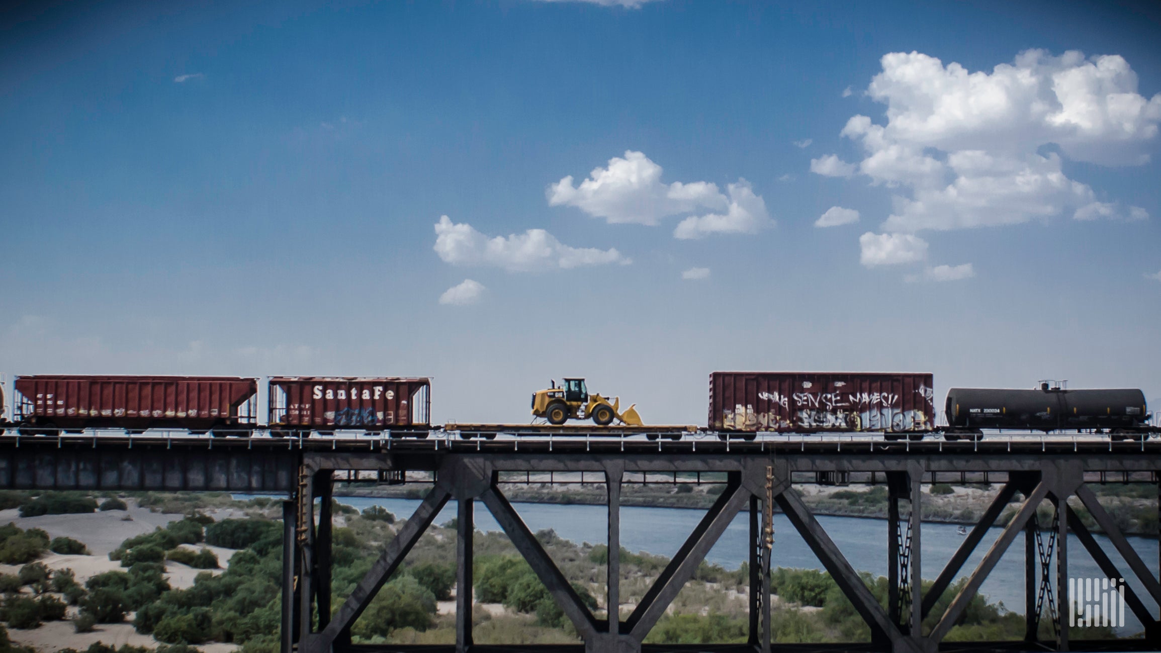 A photograph of a train crossing over a bridge.