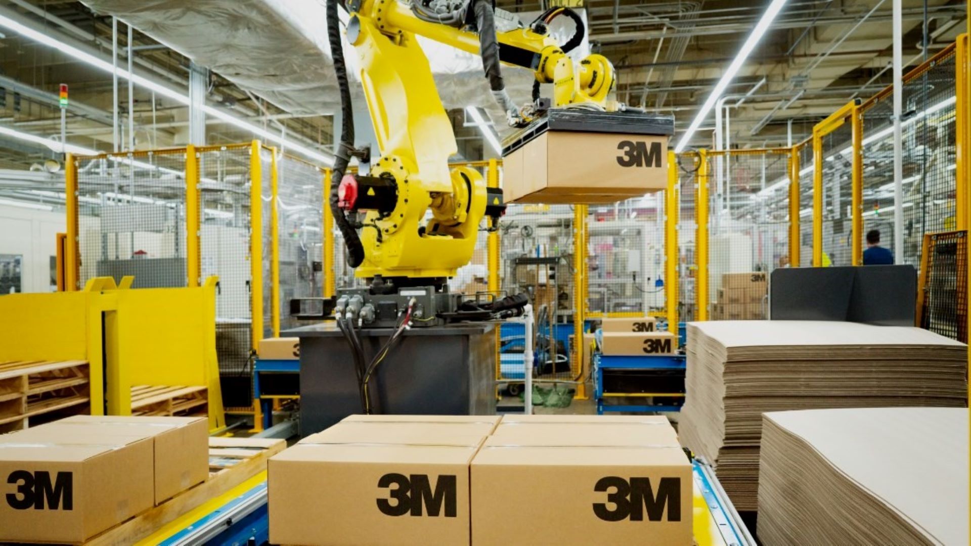 A robotic arm lifts a 3M cardboard package