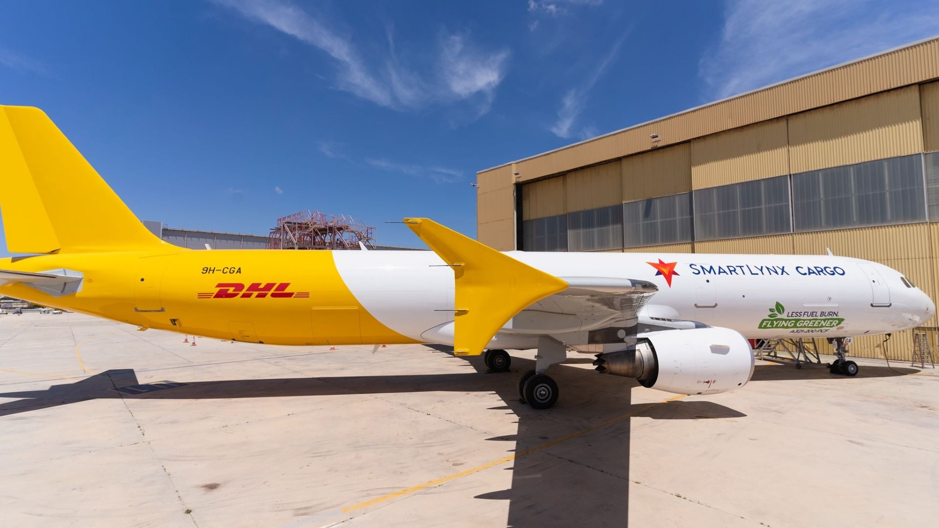 A white and gold cargo jet sporting the DHL livery.