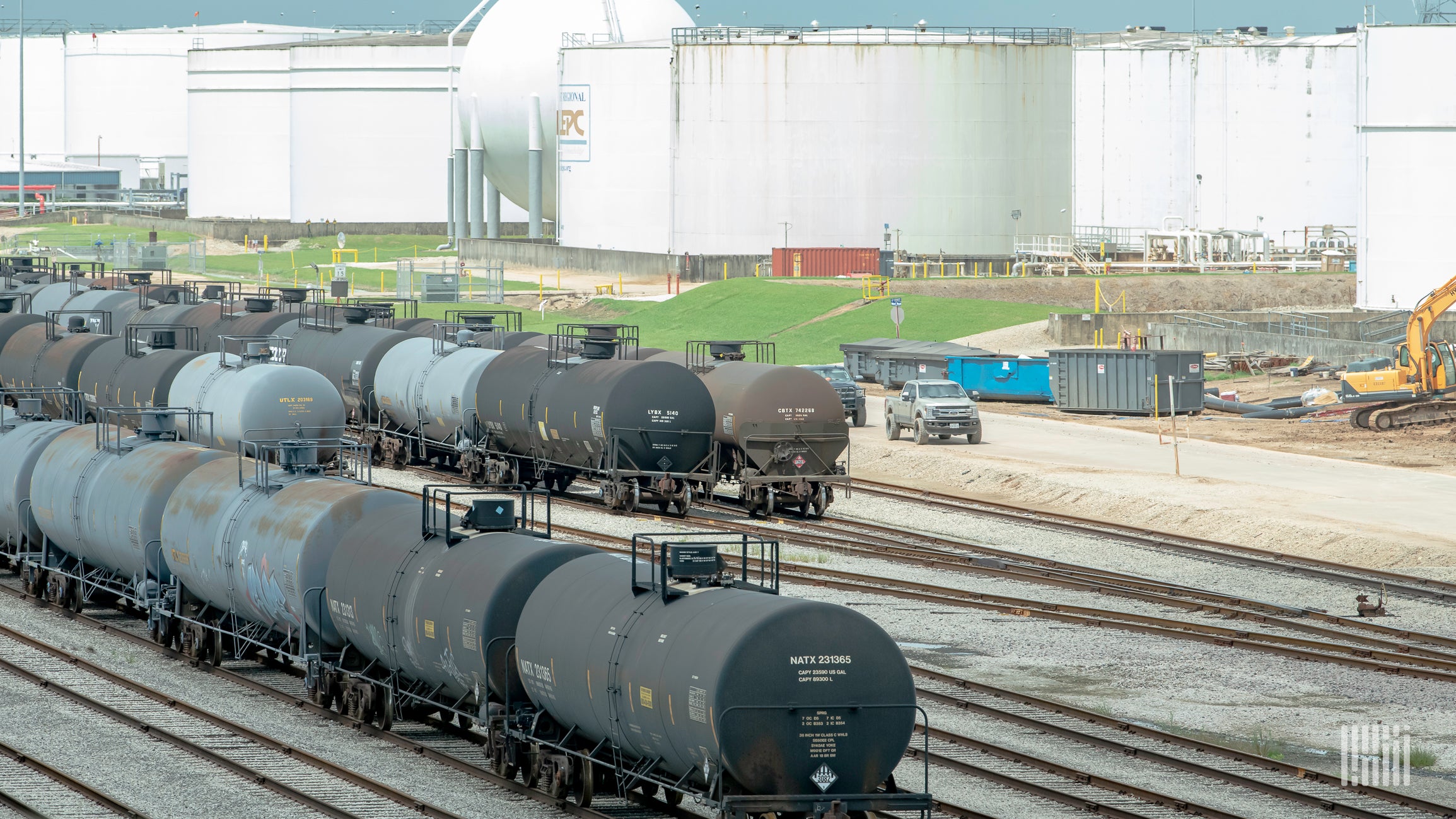 A photograph of railcars parked in a rail yard.