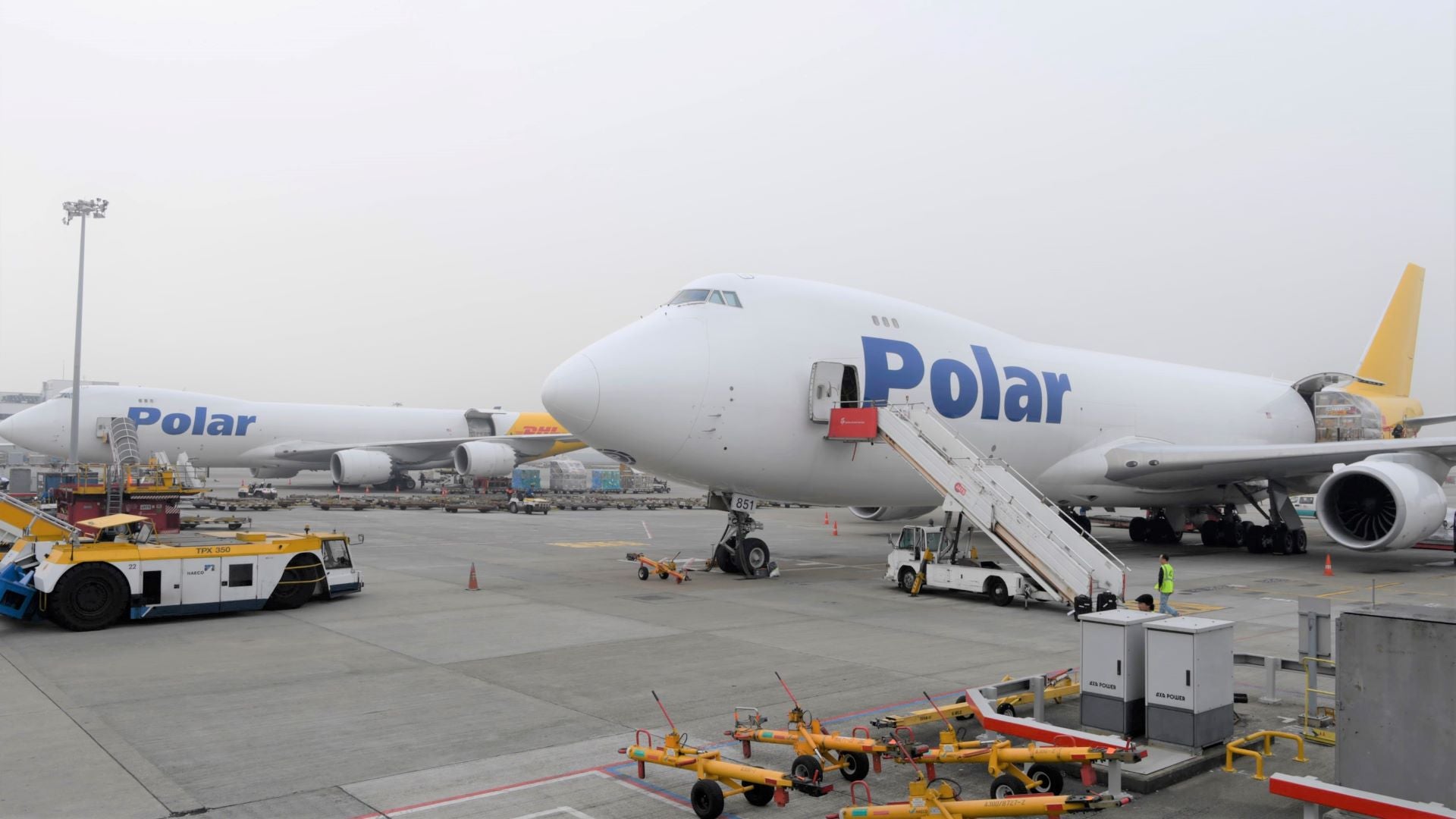 Polar Air Cargo jumbo jets side-by-side at airport being loaded with cargo.