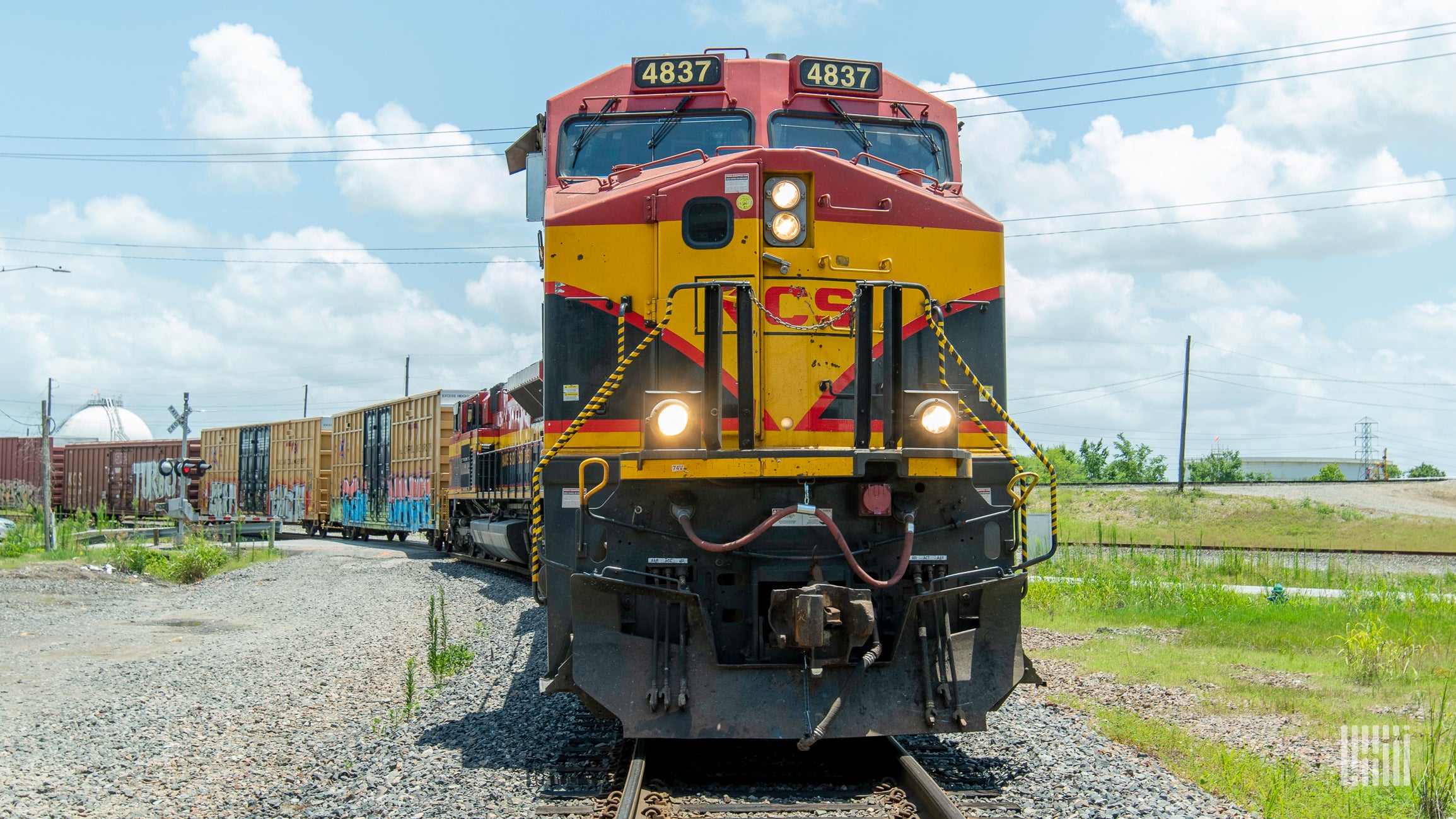 A photograph of a Kansas City Southern train hauling intermodal containers.