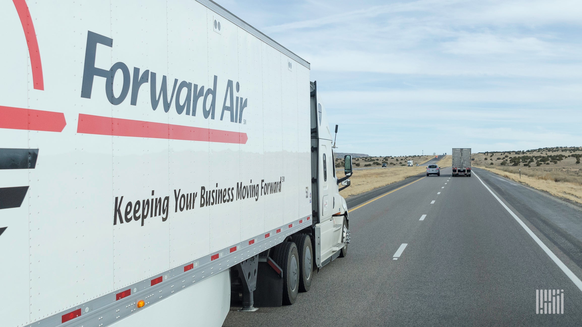 A tractor-trailer with the logo Forward Air seen from the right year side on a highway to illustrate an article about a ransomware attack on the company.