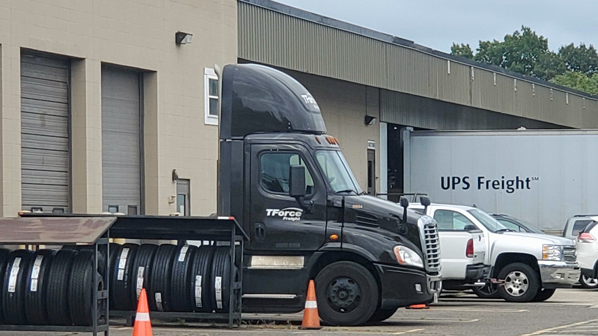 A parked TForce Freight truck with a UPS Freight in the background.