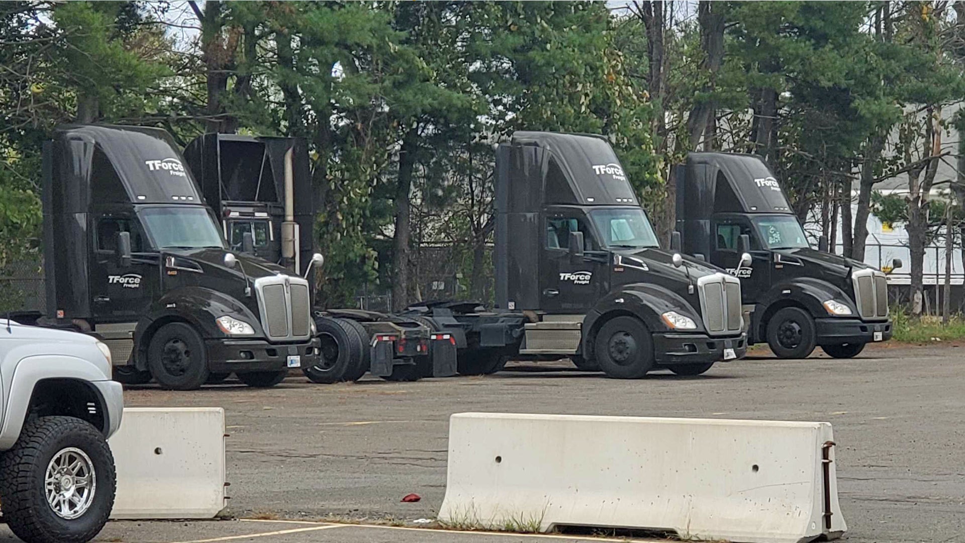 TForce Freight, owned by TFI International, trucks sit parked at a company facility. The Teamsters union has filed a complaint because TForce has limited the top speed of trucks.