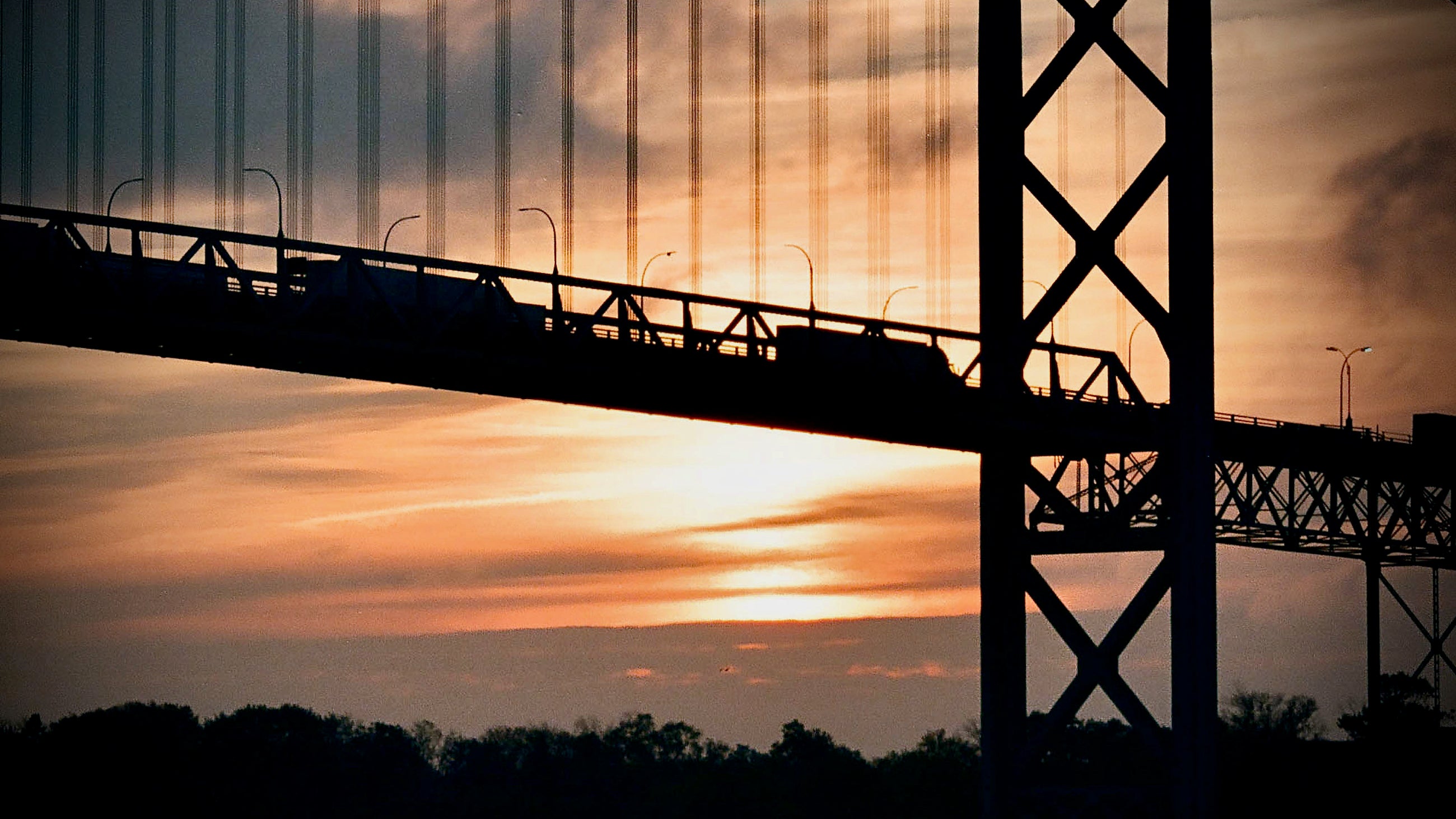 Trucks drive on the Ambassador Bridge, between Detroit and Windsor, at the U.S.-Canada border, which closed on Sept. 11, 2001.