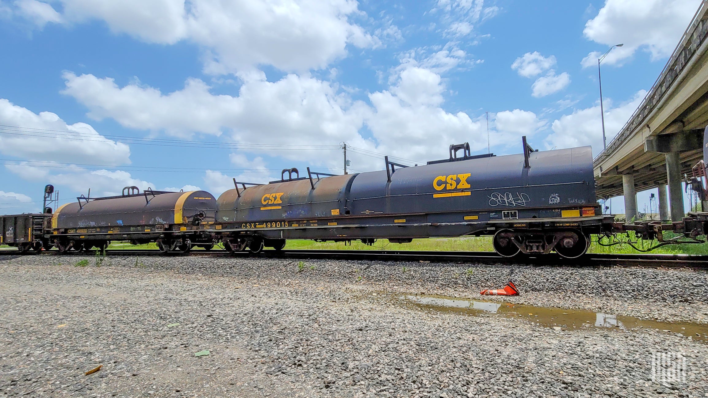 A photograph of a CSX train hauling tank cars.