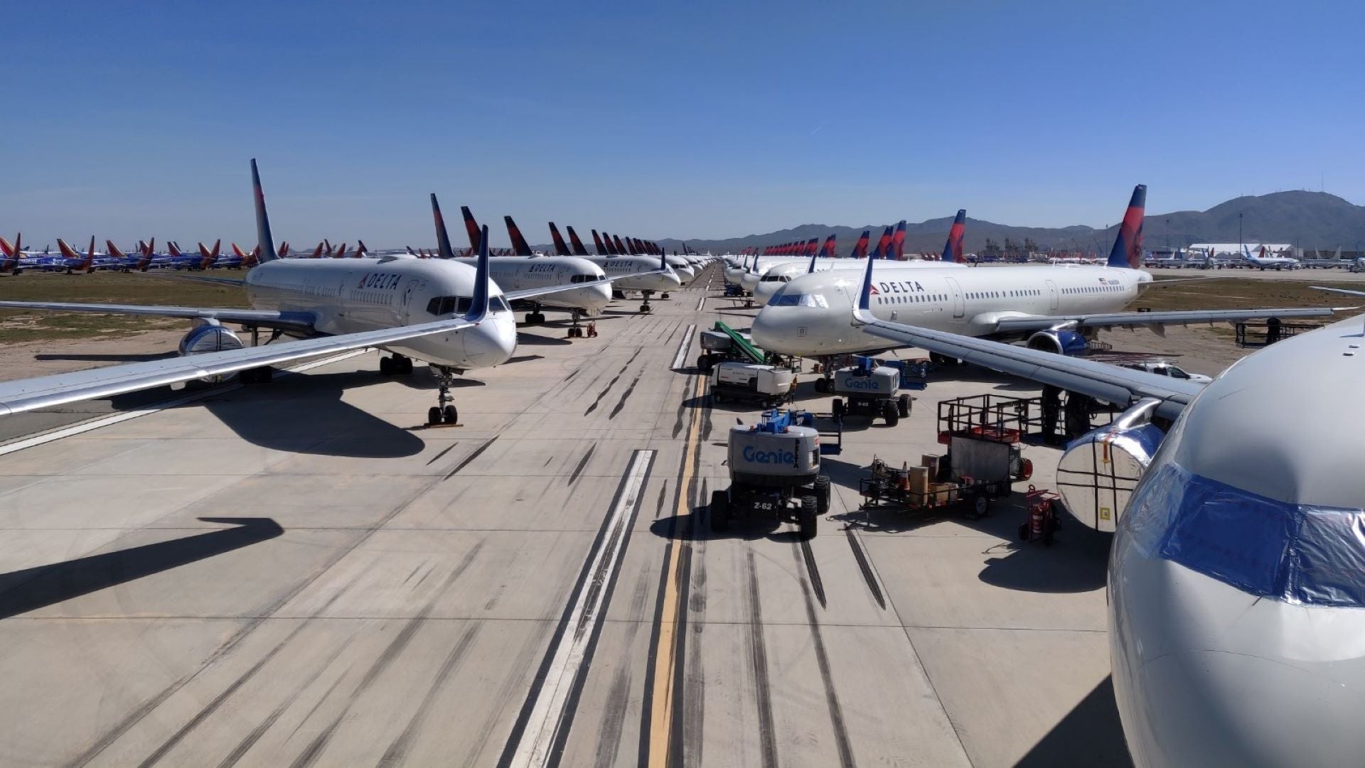 Delta aircraft stored wing-to-wing on an airfield.