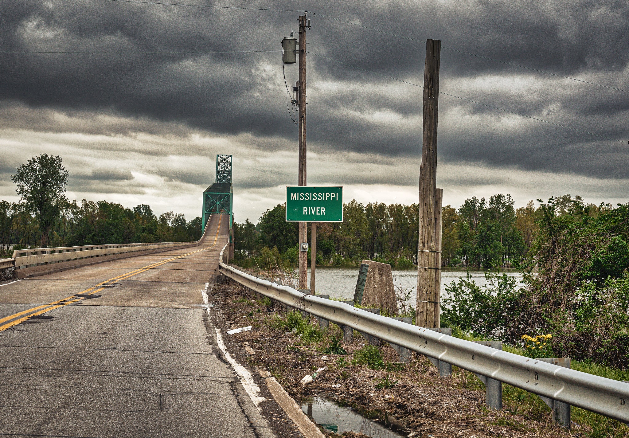 A photograph of a rural highway crossing the Mississippi River.