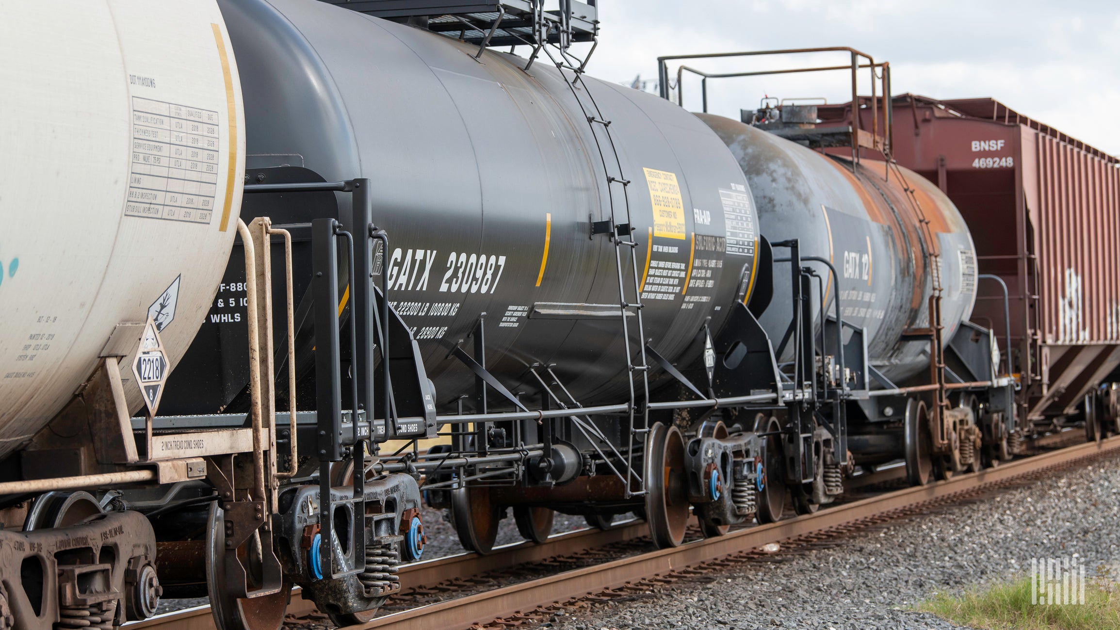 A photograph of a train hauling a variety of railcars.