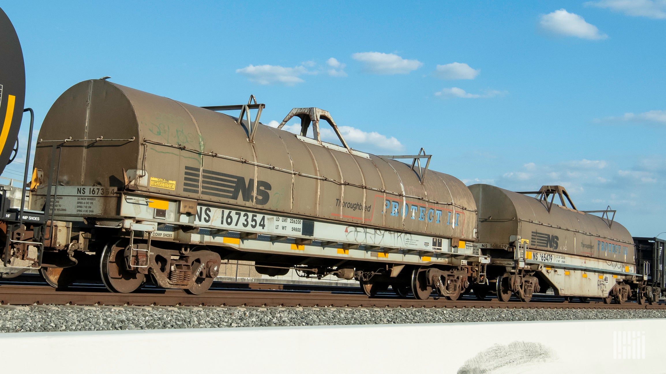 A photopgraph of tank cars parked in a rail yard.