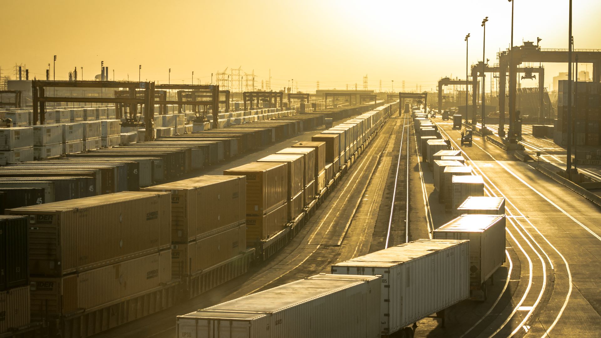 Sunset on a big container rail yard.