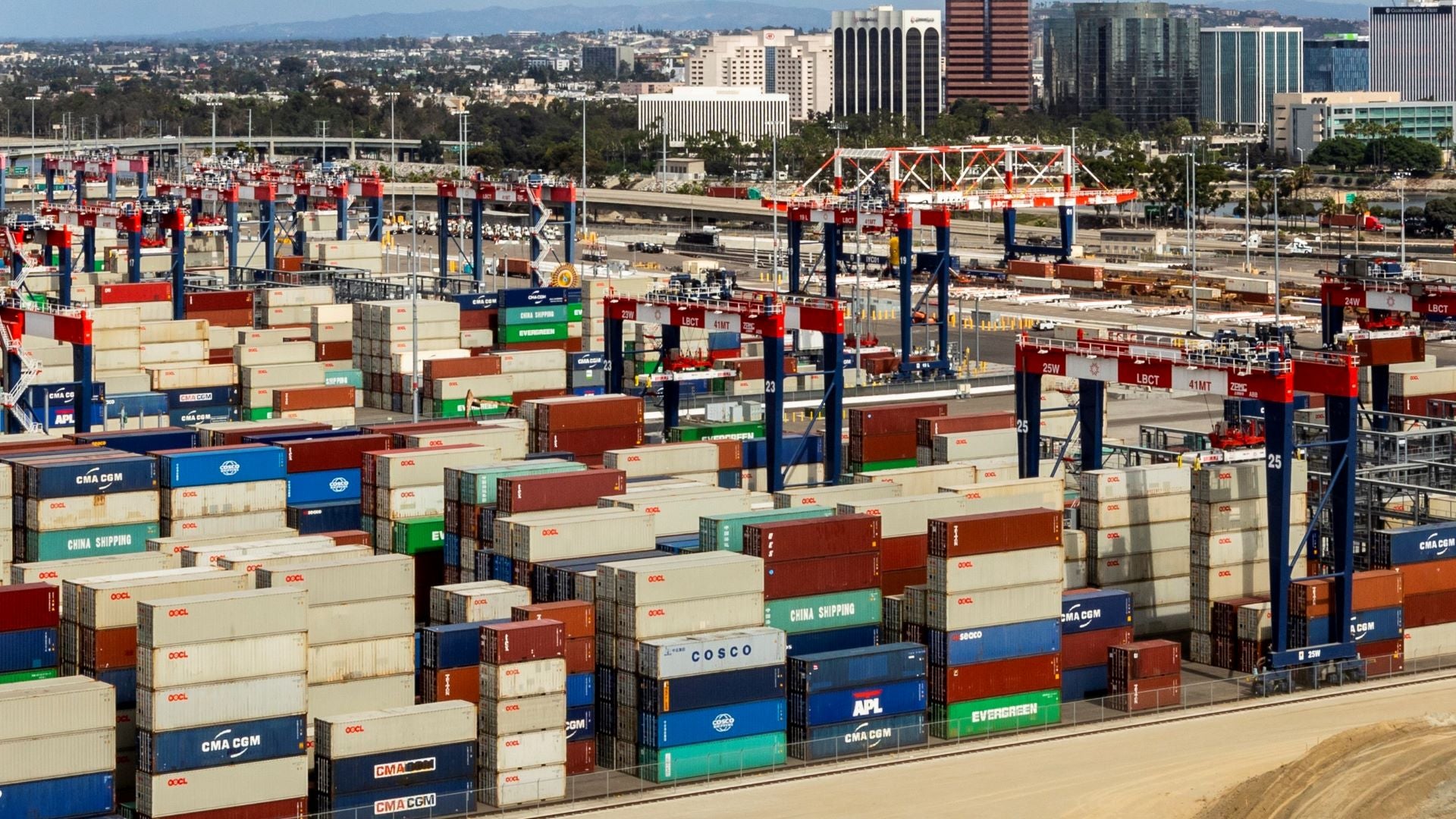 Aerial view of containers stacked at a port.