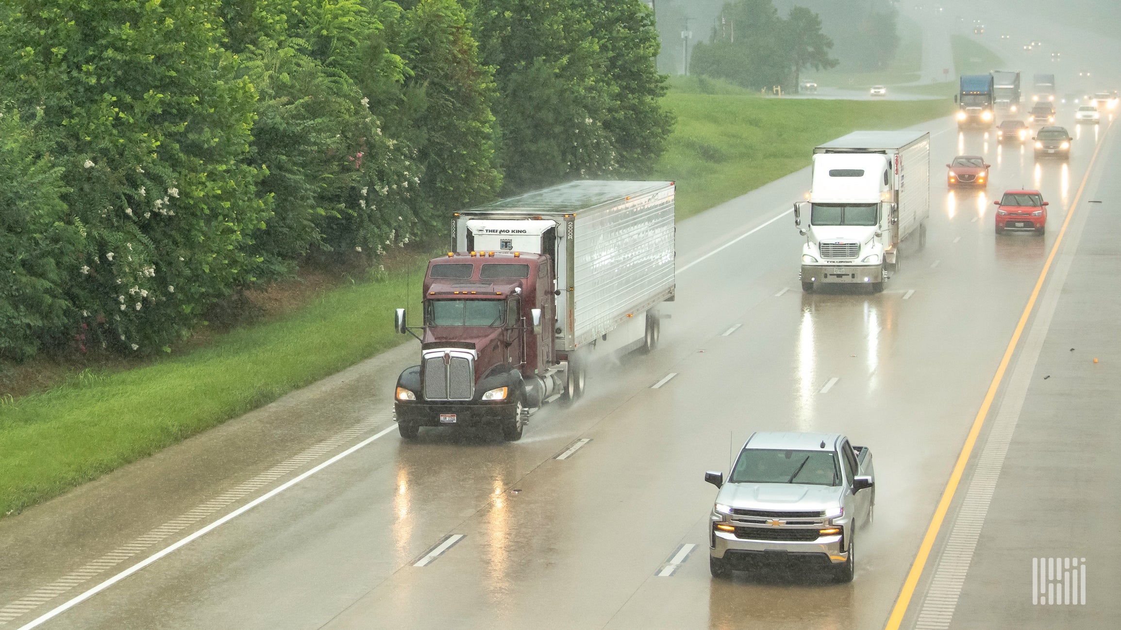 Tractor-trailers in heavy rain.