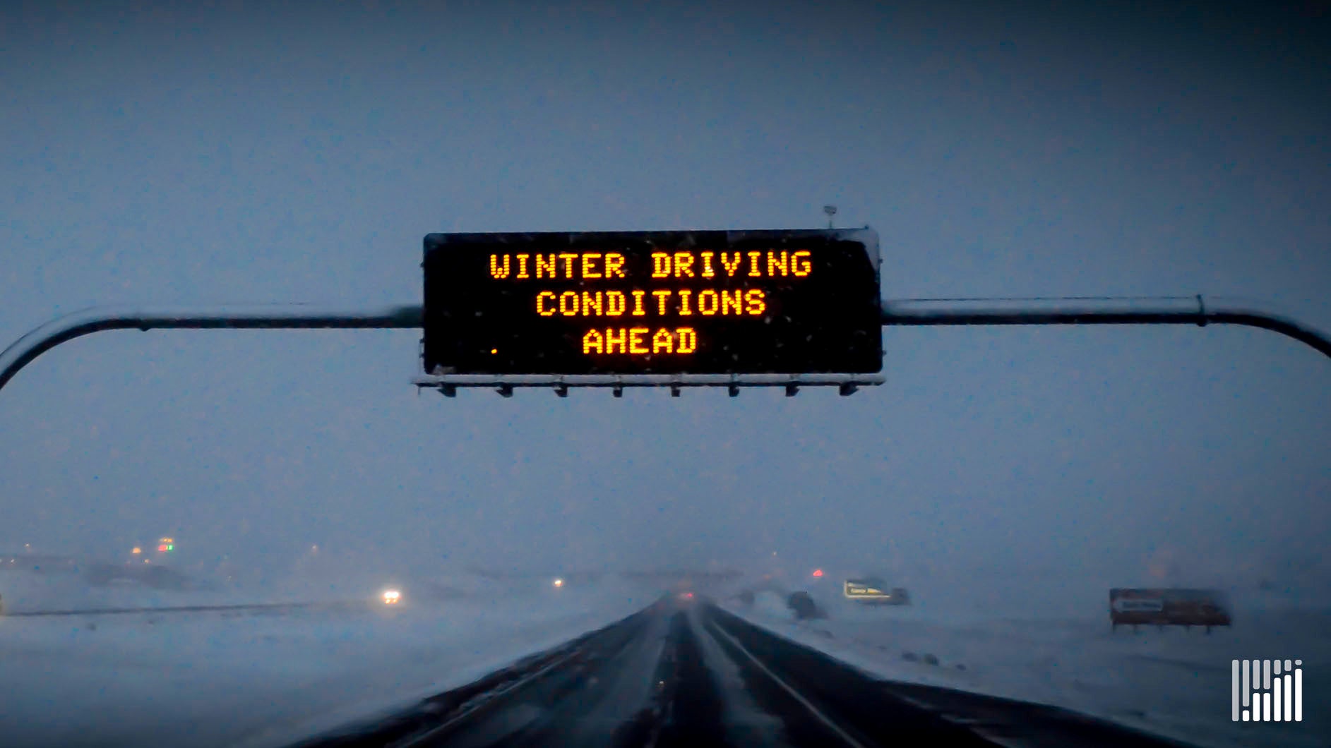 "Winter Driving Conditions Ahead" road sign.