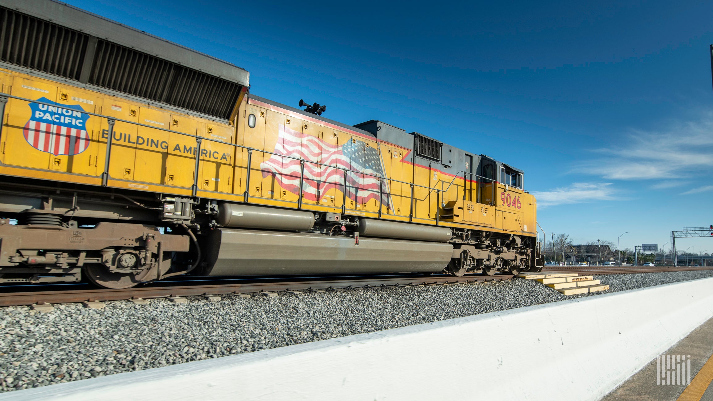 A photograph of a Union Pacific train rolling down a rail yard.