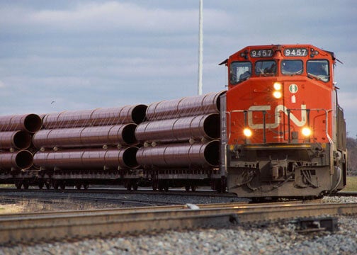 A photograph of a CN train hauling metals equipment.