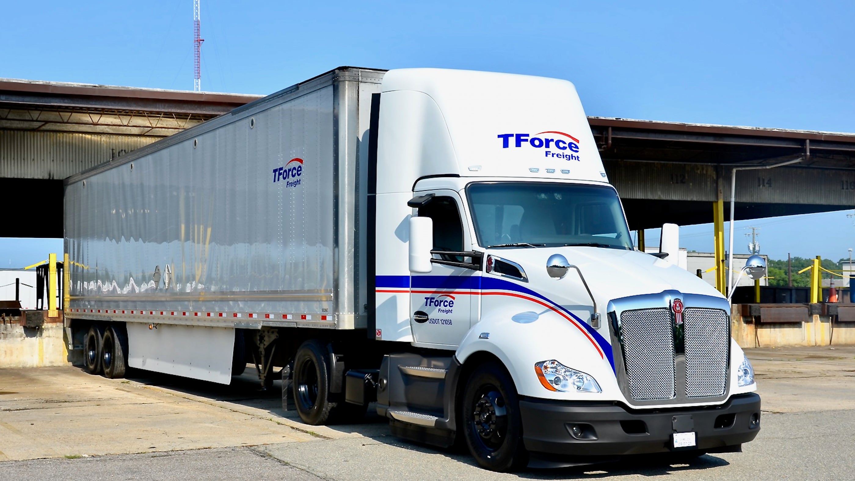 A tractor-trailer of TFI International's TForce Freight, formerly UPS Freight, seen from the front left.