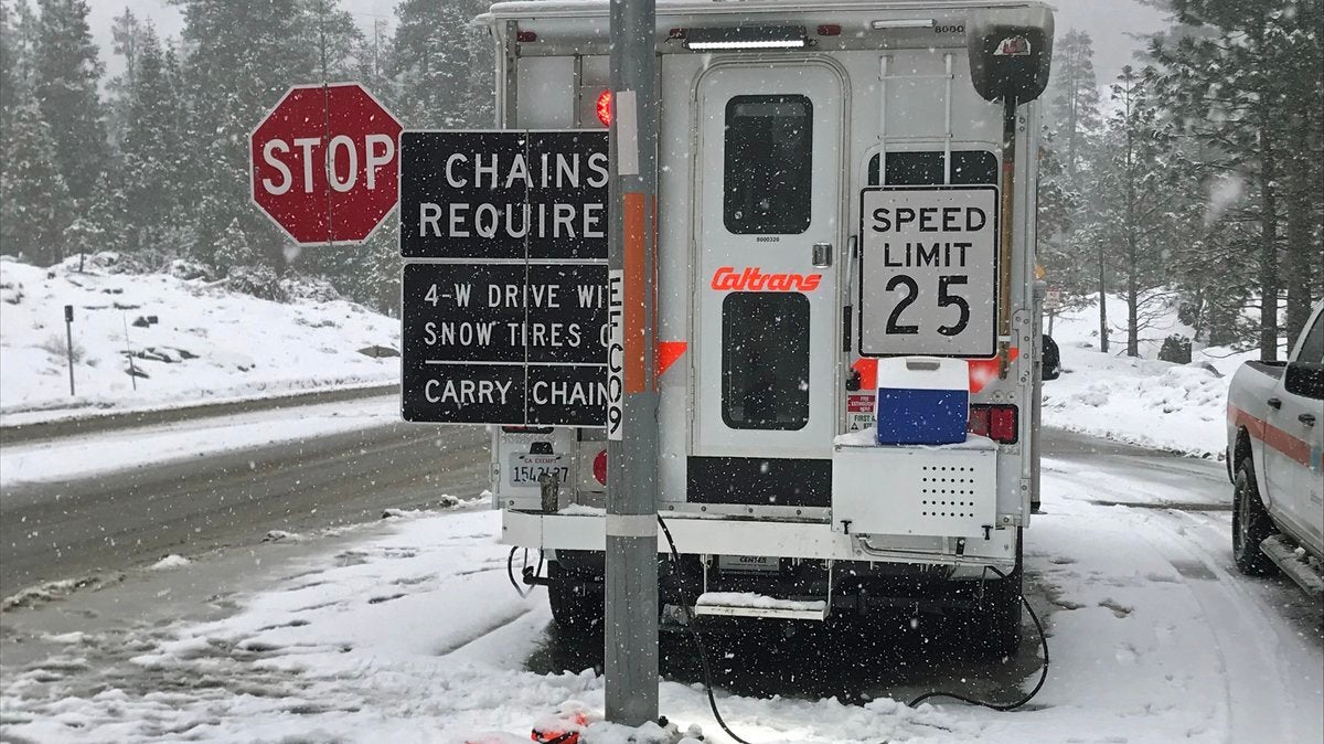 Caltrans truck on a snowy California highway.