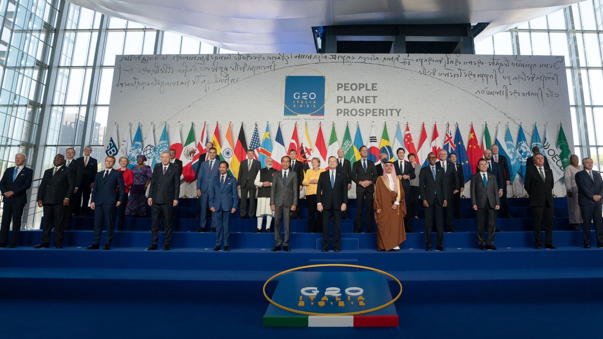 Leaders stand in front of flags at G20 summit in Rome