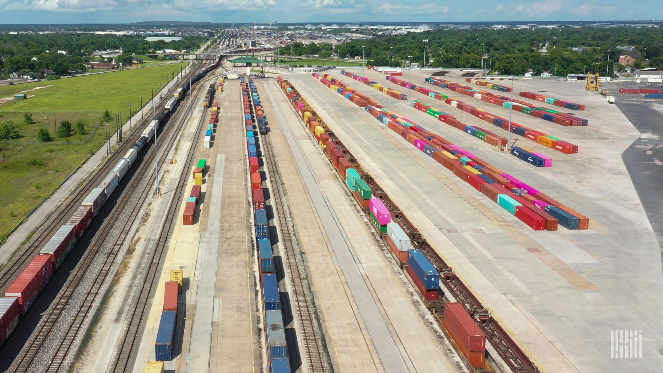 A photograph of containers parked at a rail yard.