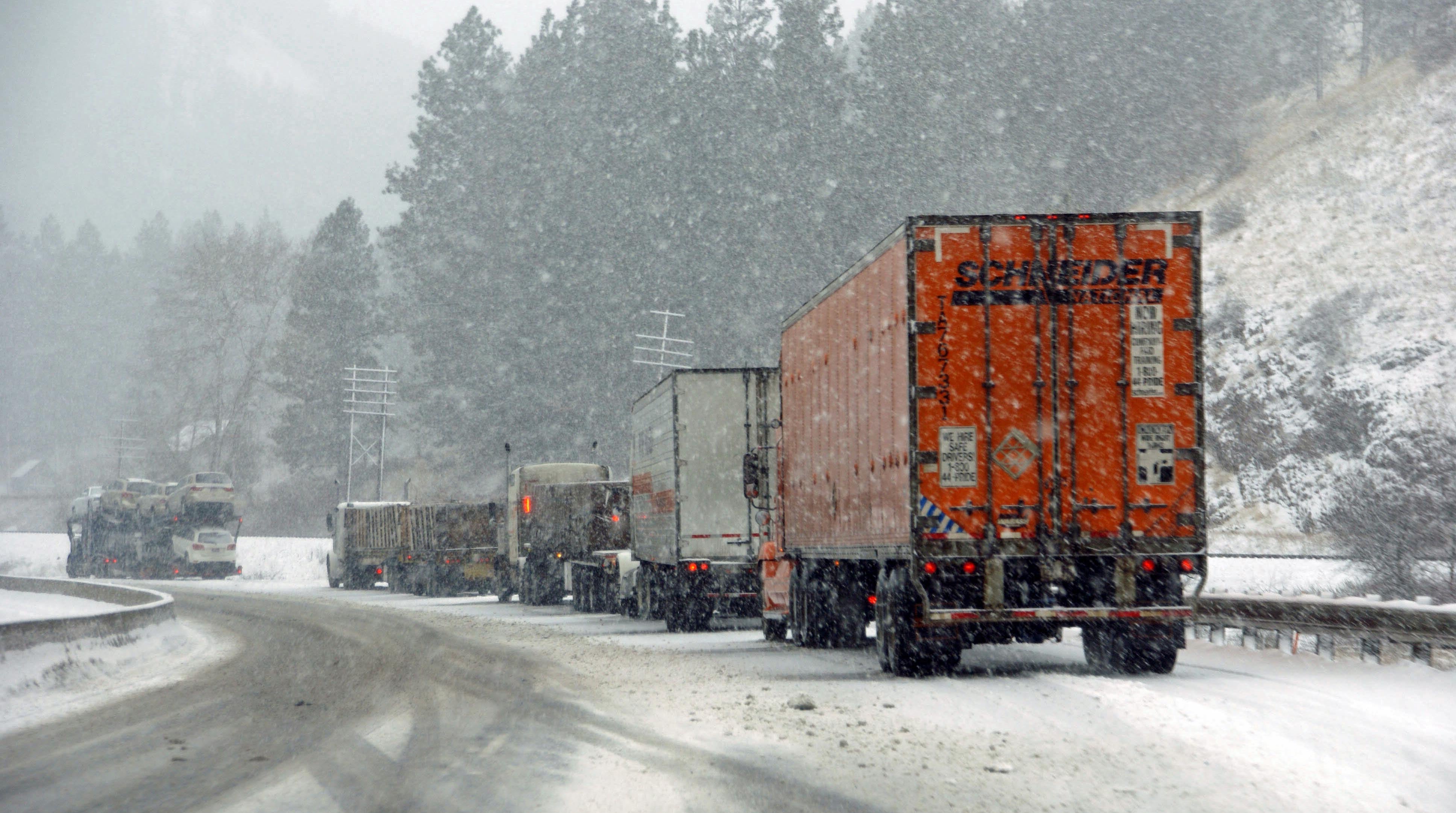 Tractor-trailers on a snowy road.