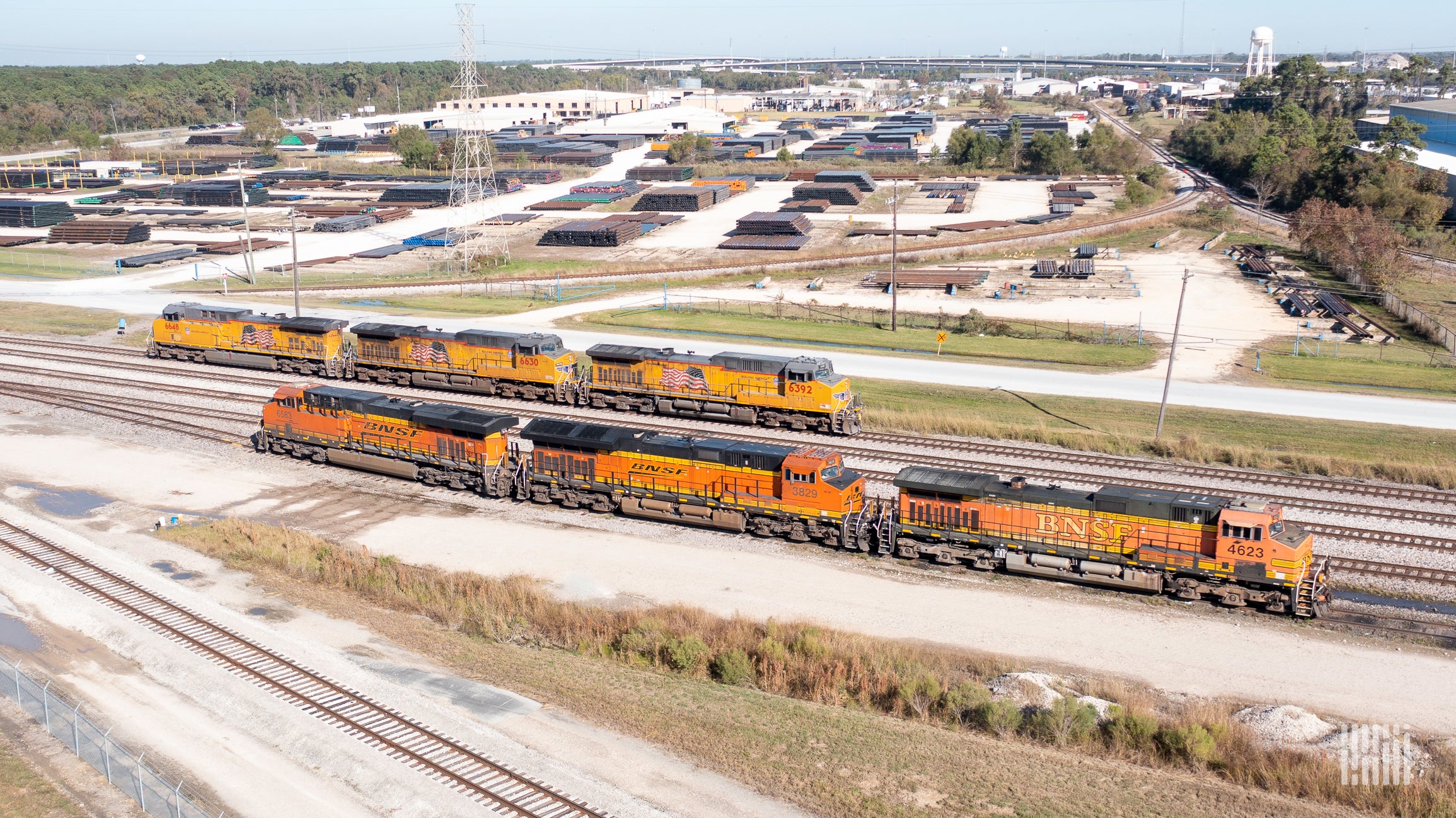 A photograph of a Union Pacific train and a BNSF train in a rail yarrd.