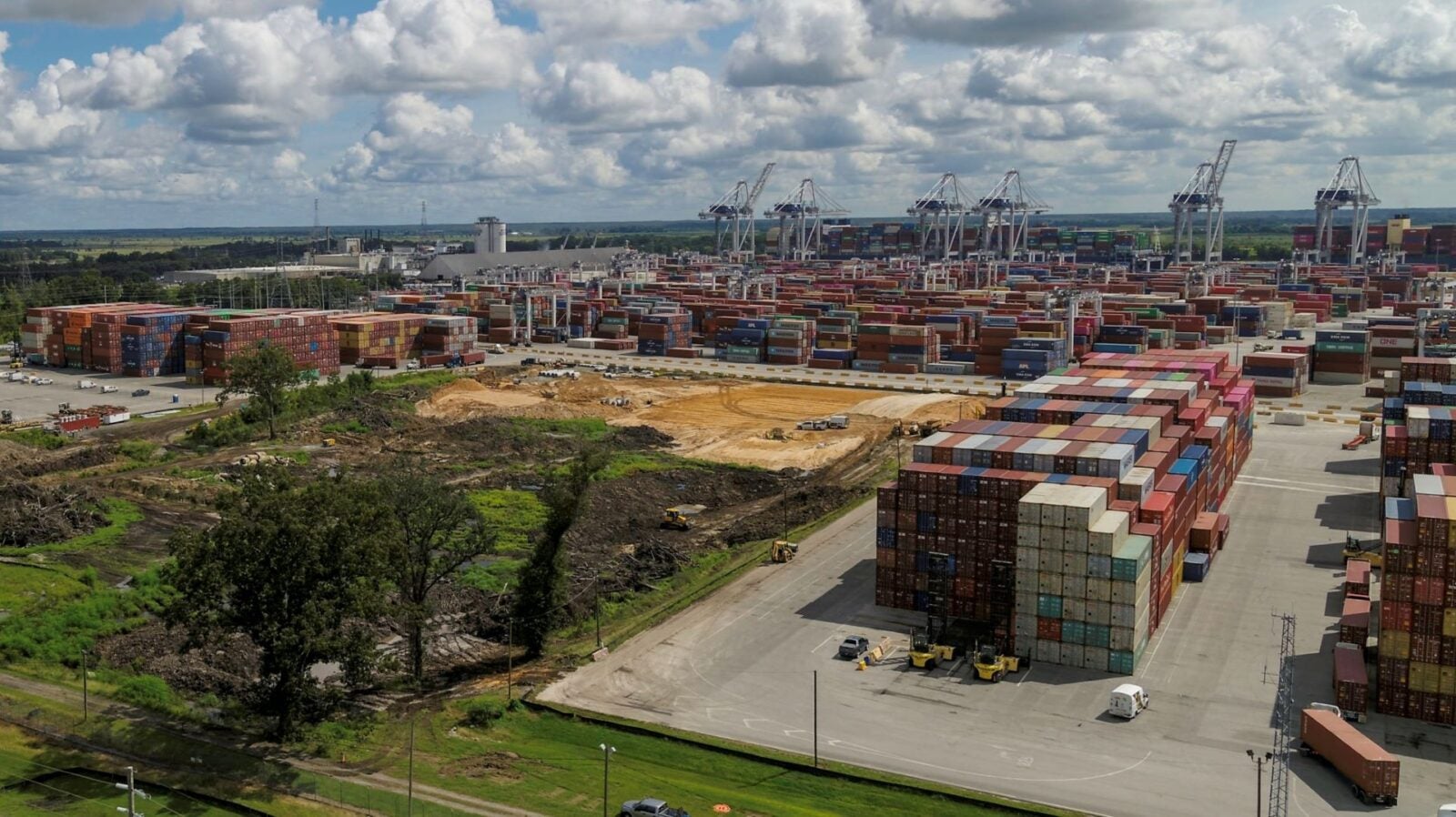 A parcel of land being cleared to expand an existing container storage area.