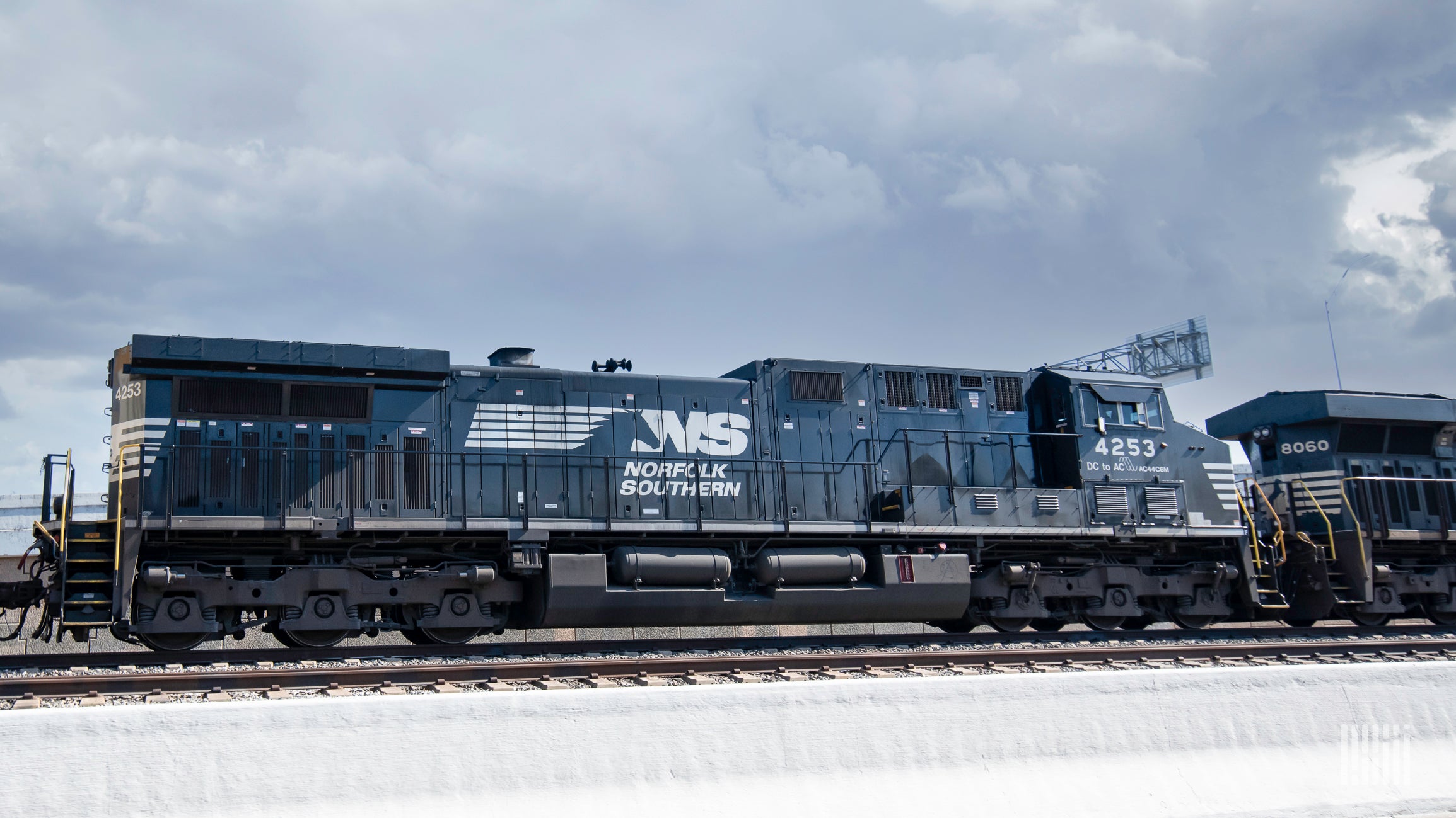 A photograph of a Norfolk Southern locomotive rolling down a train track.