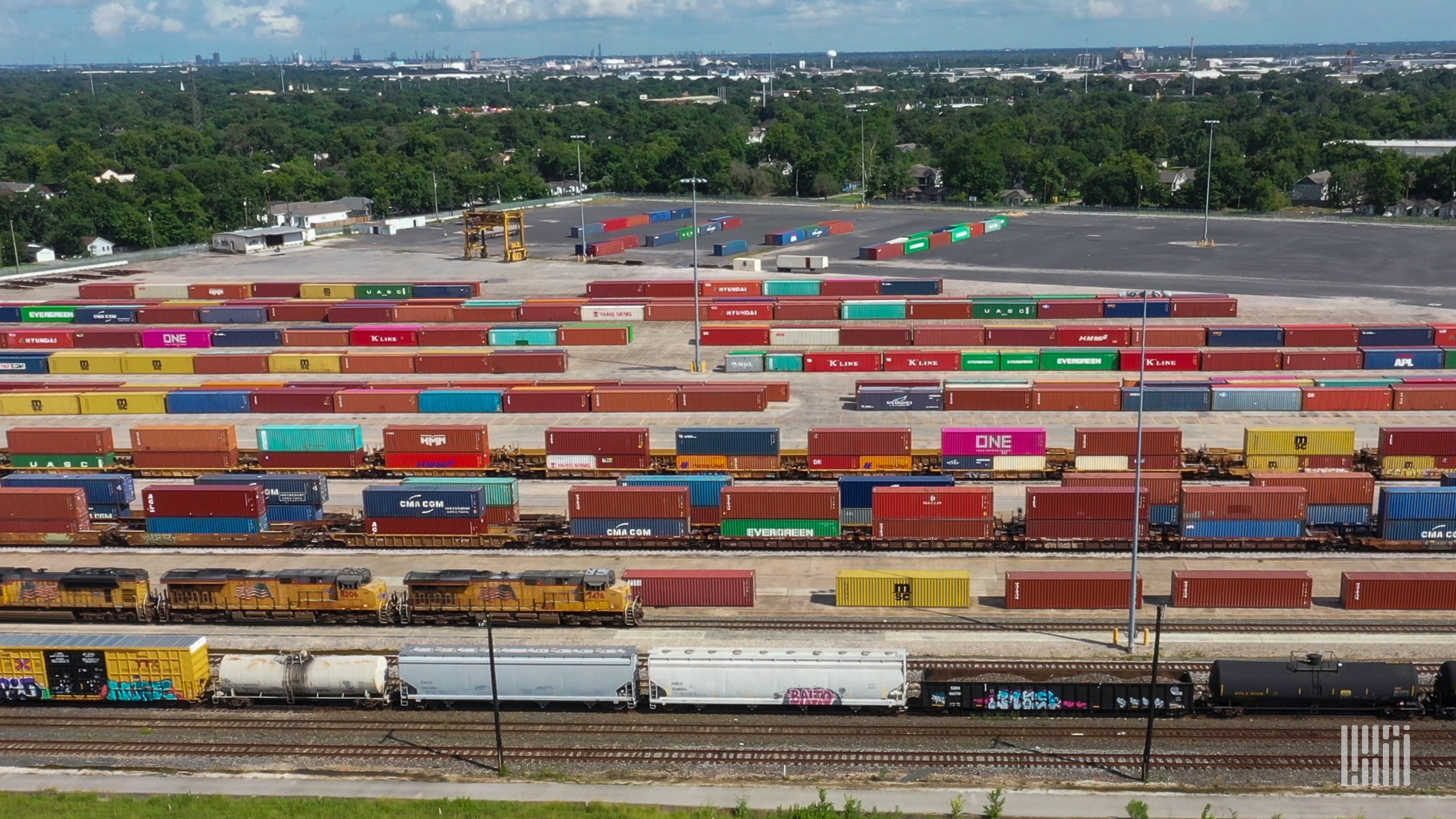 A photograph of intermodal containers parked in a rail yard.