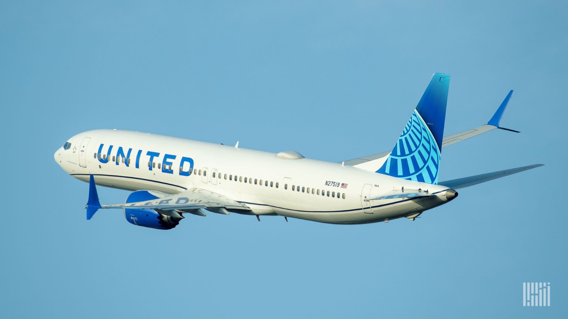 A white United Airlines jet with blue tail is airborne, heading away from camera.