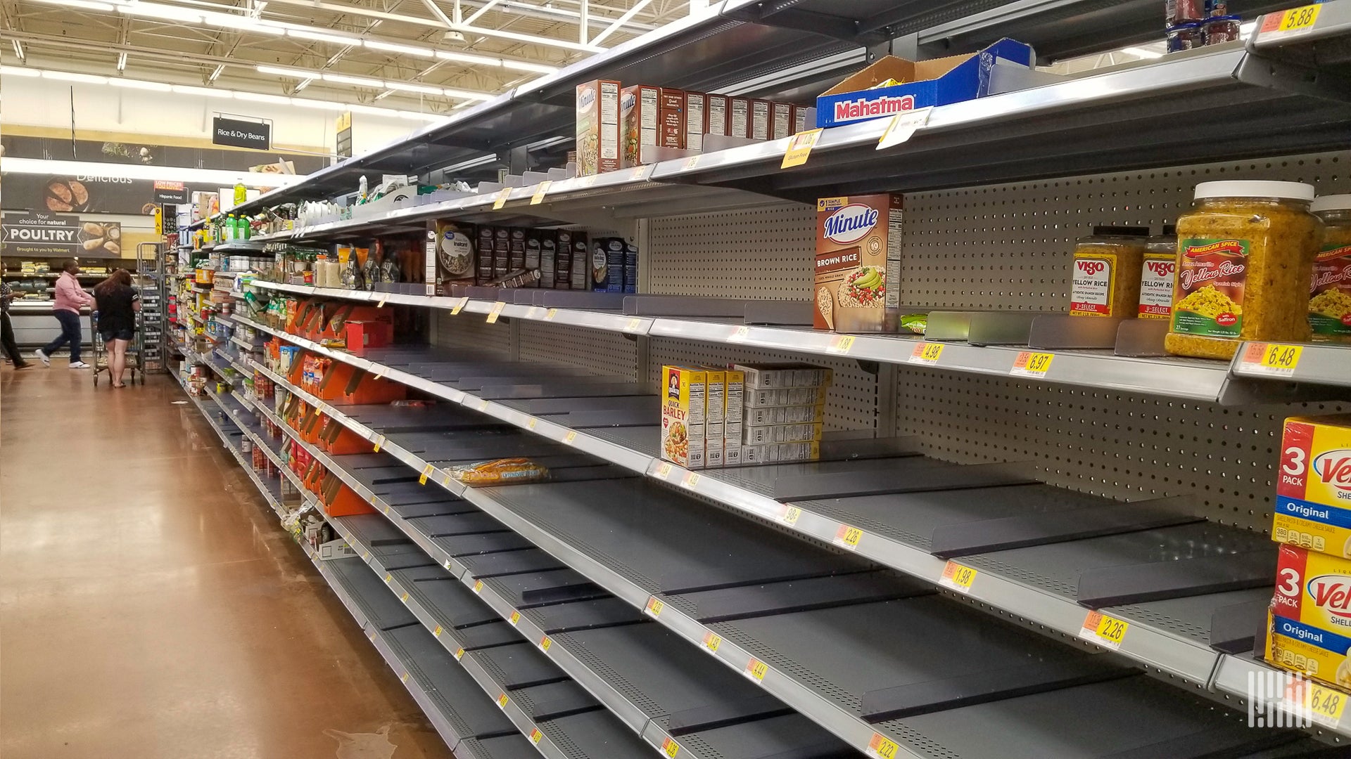 View of half-empty shelf in a grocery store.