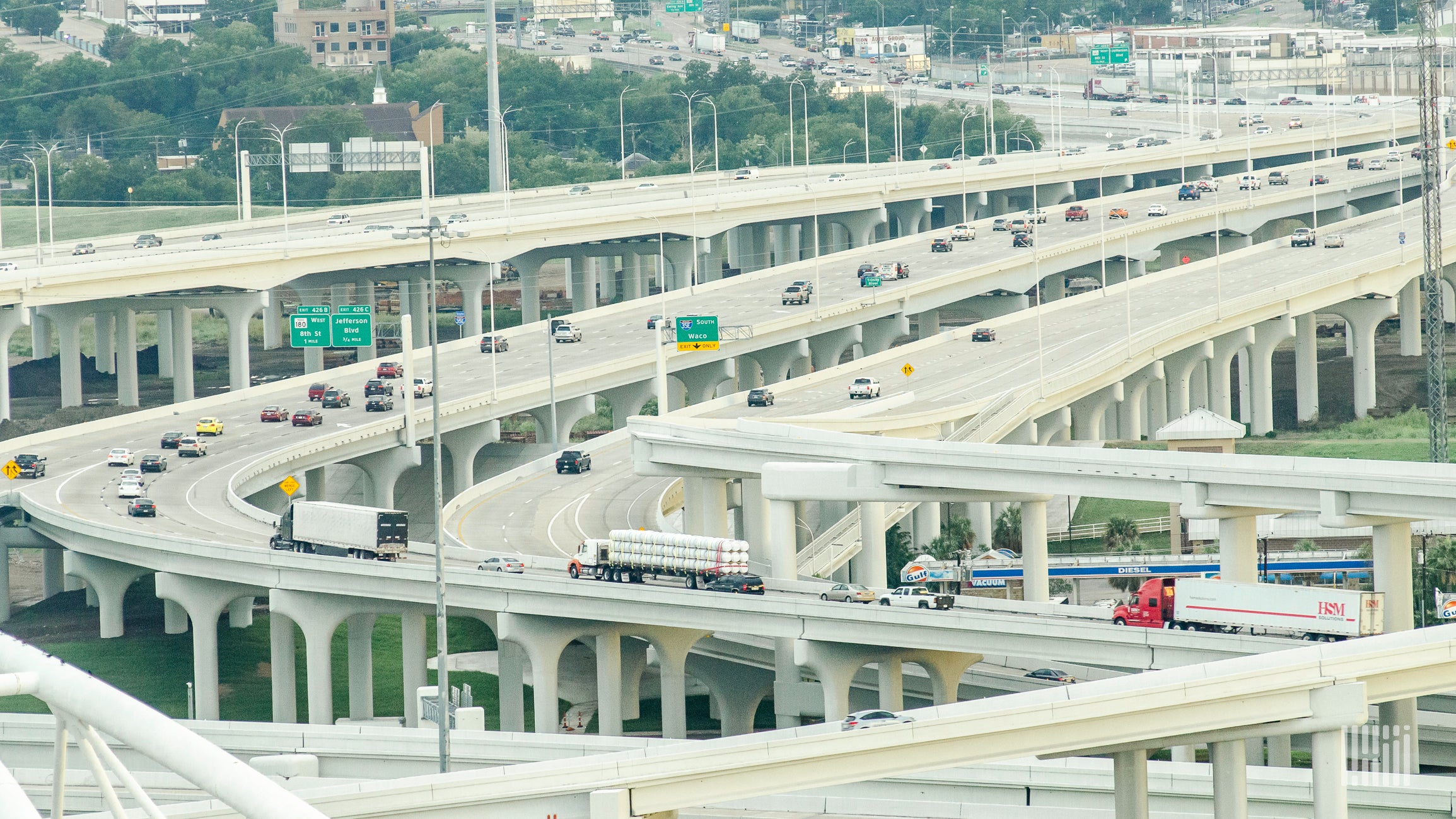 Cars and trucks moving on major freeway interchanges.