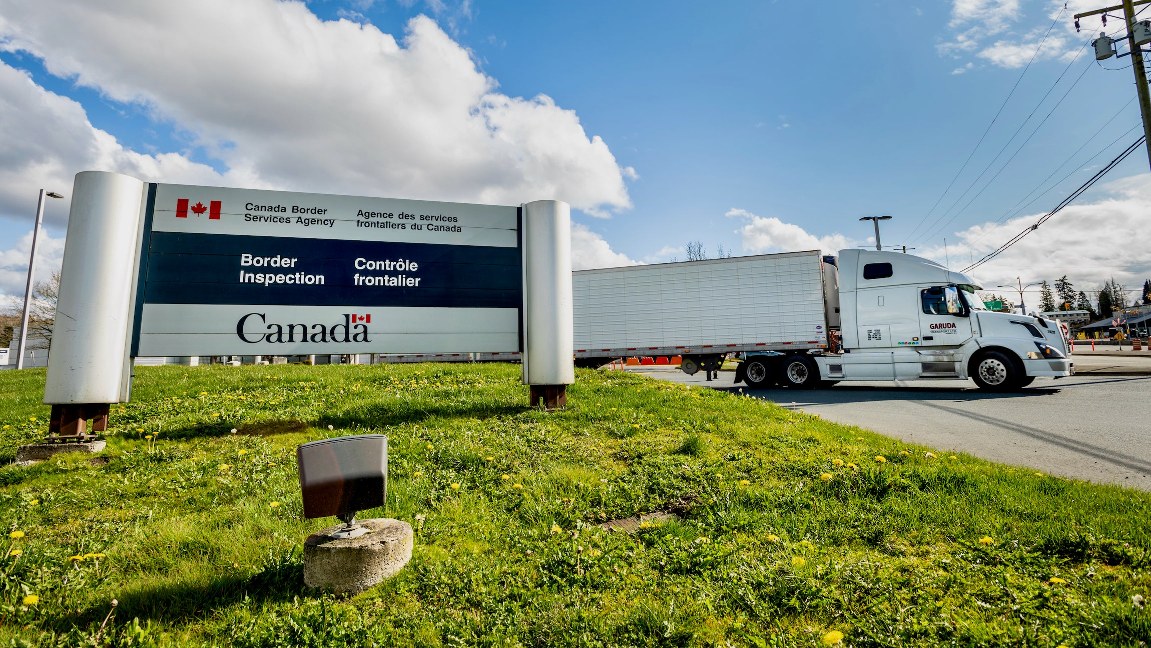 Surrey, Canada - Mar 29, 2020: Freight truck exiting Canadian Border Services Pacific Truck Crossing location during Coronavirus Covid-19 pandemic