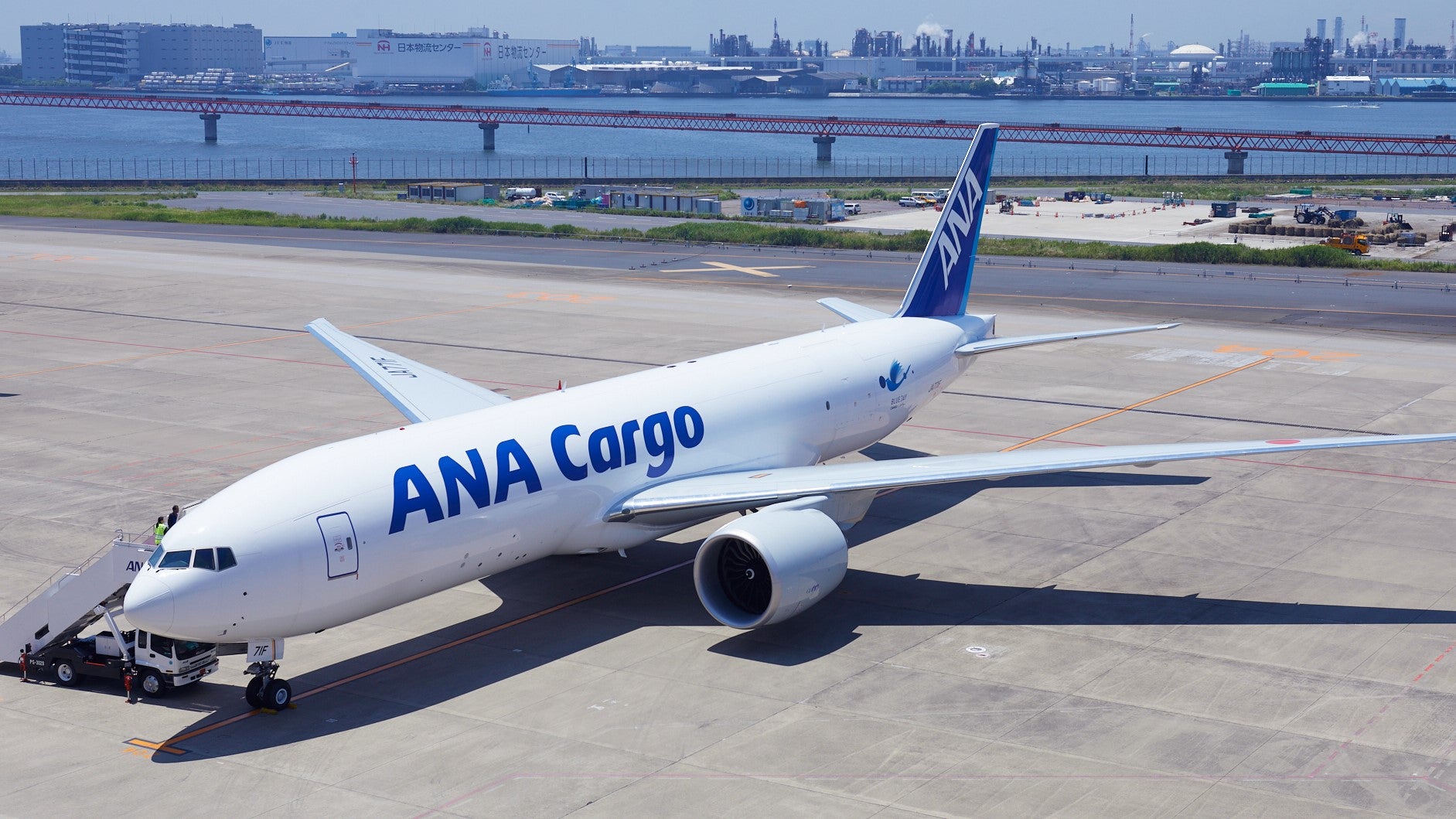 An angle view from above of white jet with blue lettering ANA Cargo.