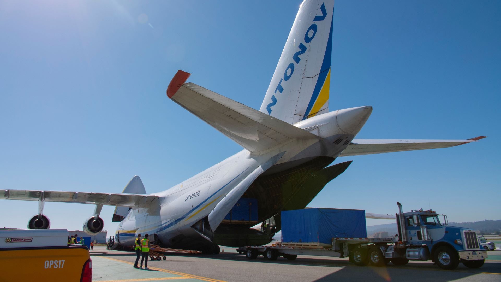 A massive freighter with a big rear and front door open, view from rear.