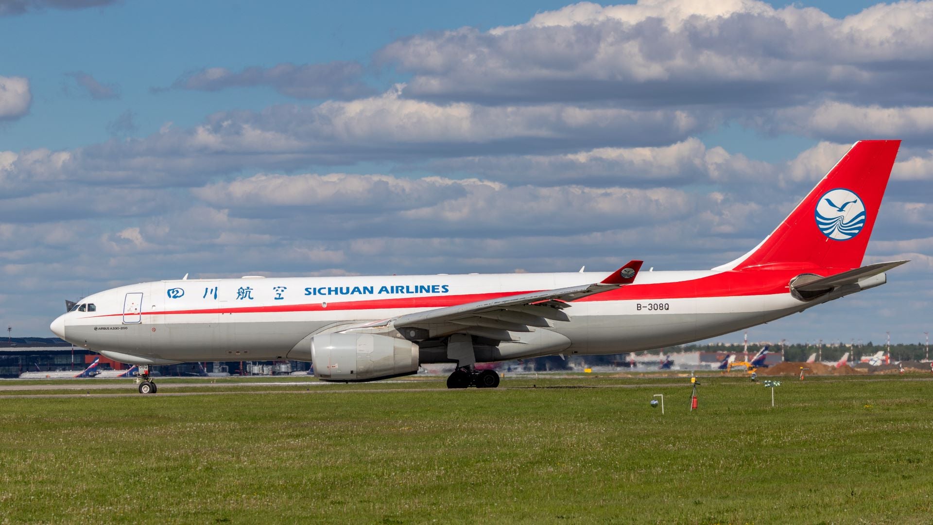 A white-and-red Sichuan Airlines jet on the tarmac.