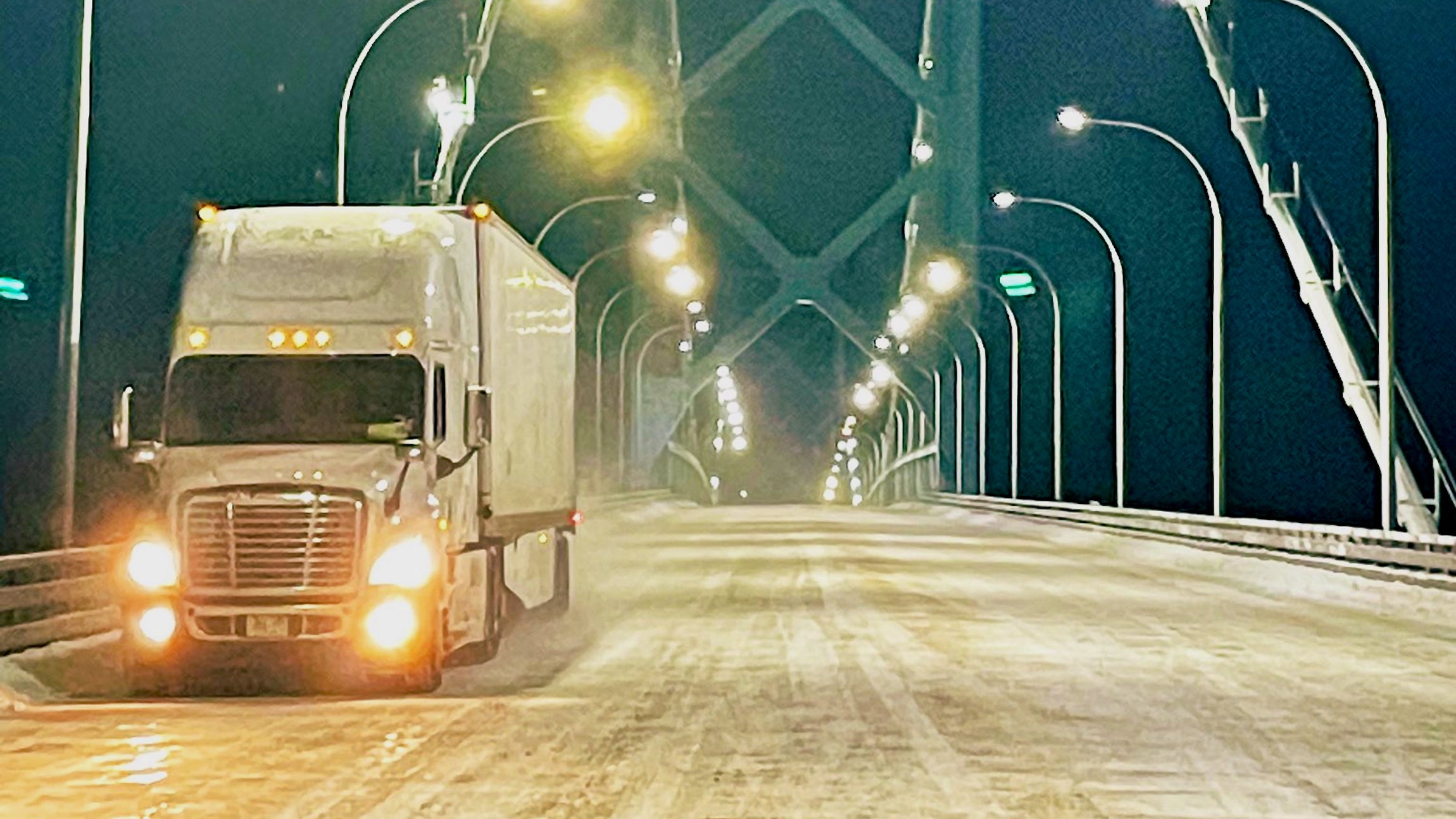 A truck crosses the Ambassador Bridge after the US-Canada border bridge reopened.