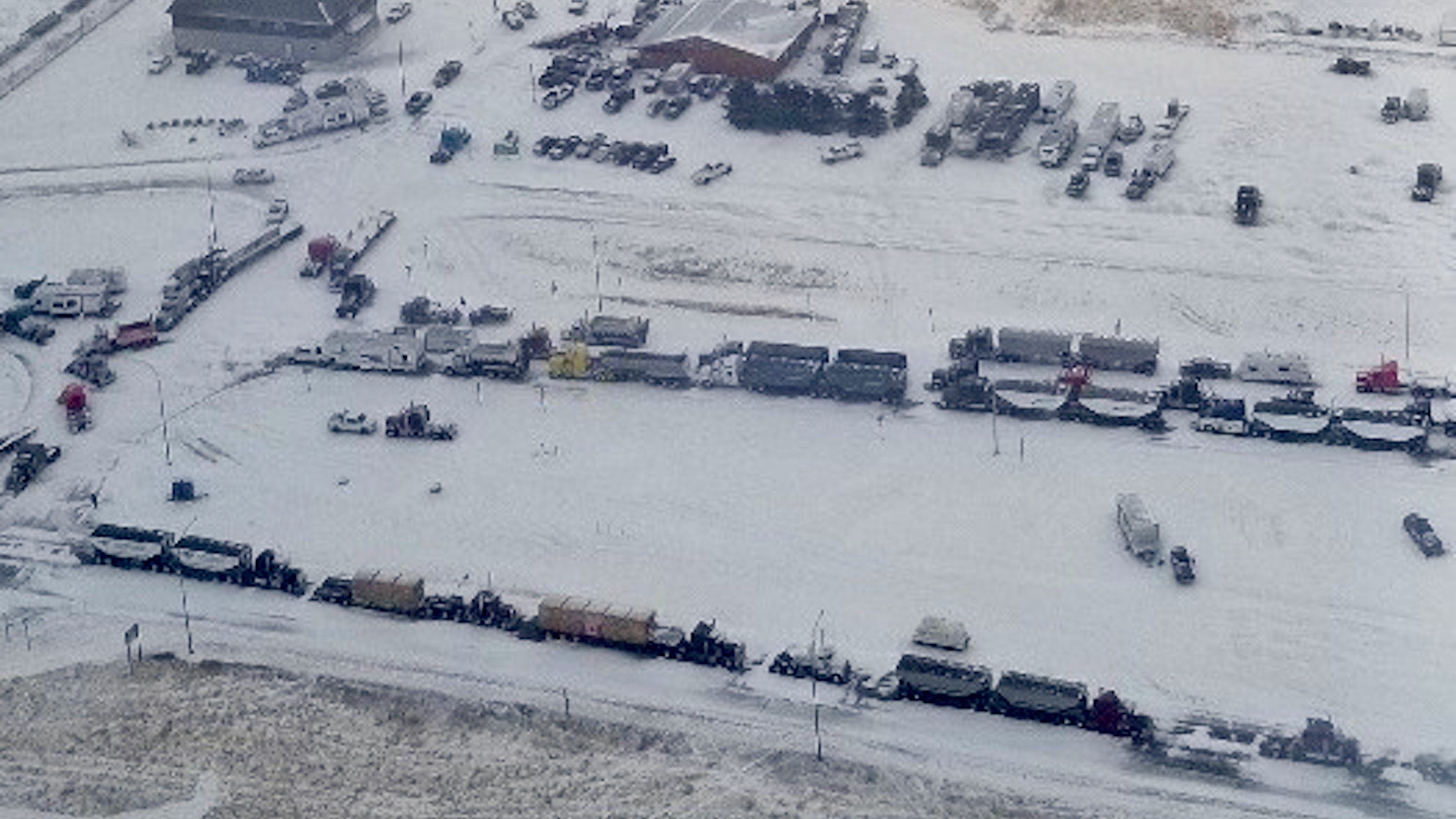 An aerial photo shows trucks blocking the Coutts, Alberta US-Canada border crossing.