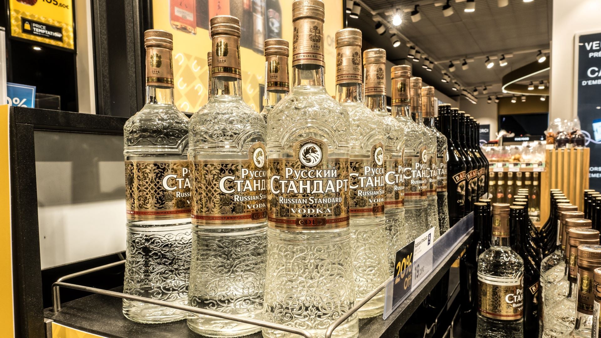 Bottles of vodka lined up at a bar.