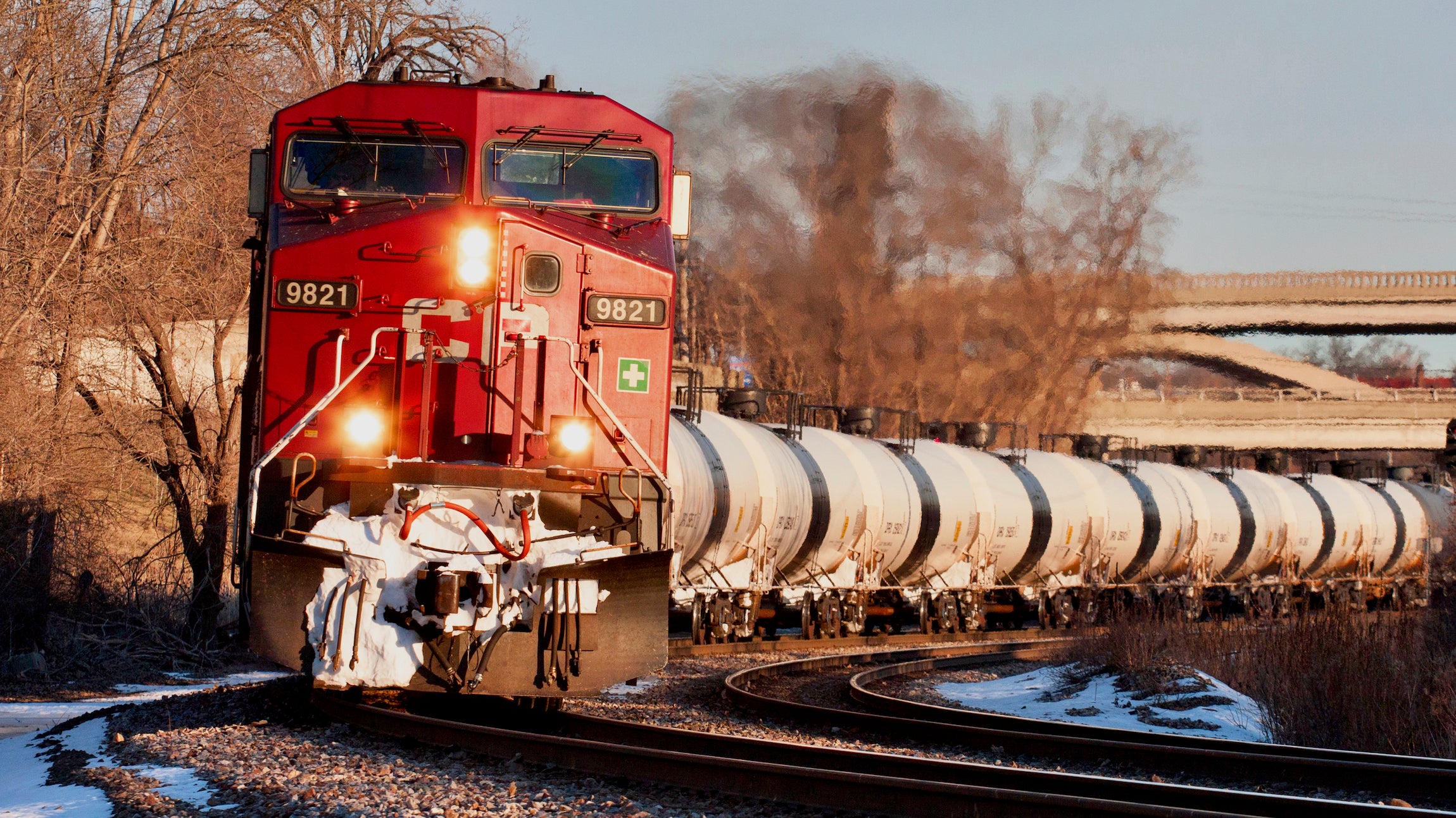 A red Canadian Pacific Railway train pulling tanker cars