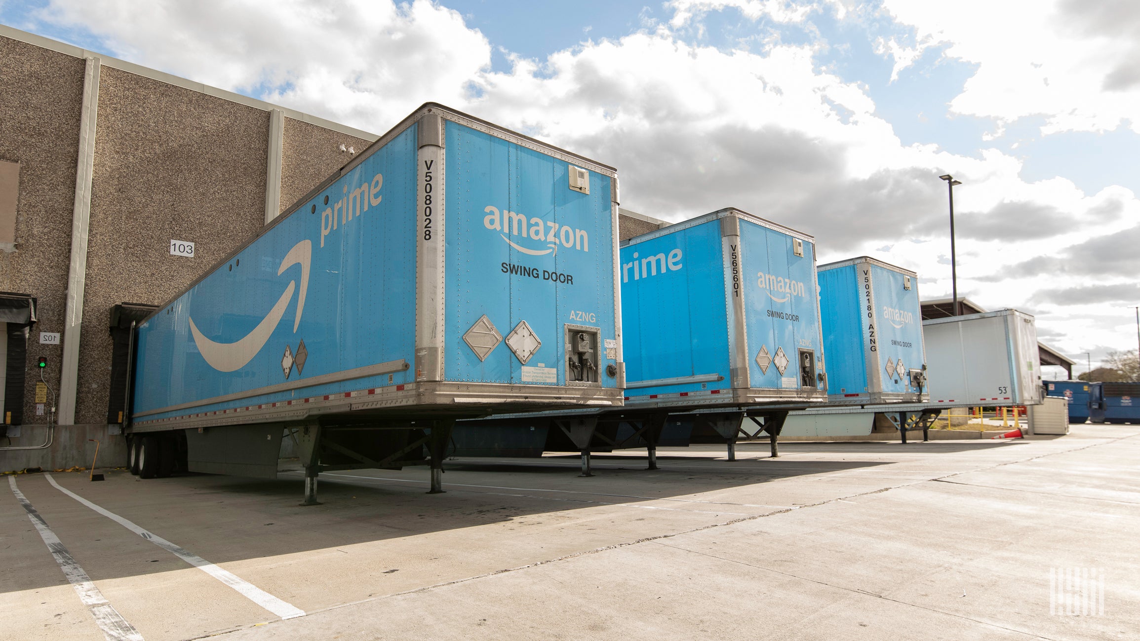 Amazon trailers sit outside an Amazon warehouse