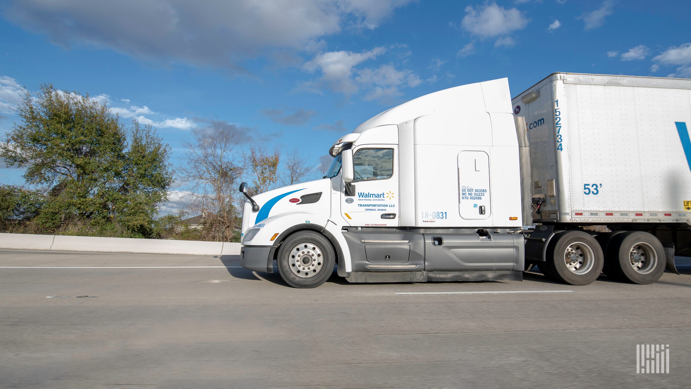 A white Walmart tractor-trailer seen from the side.