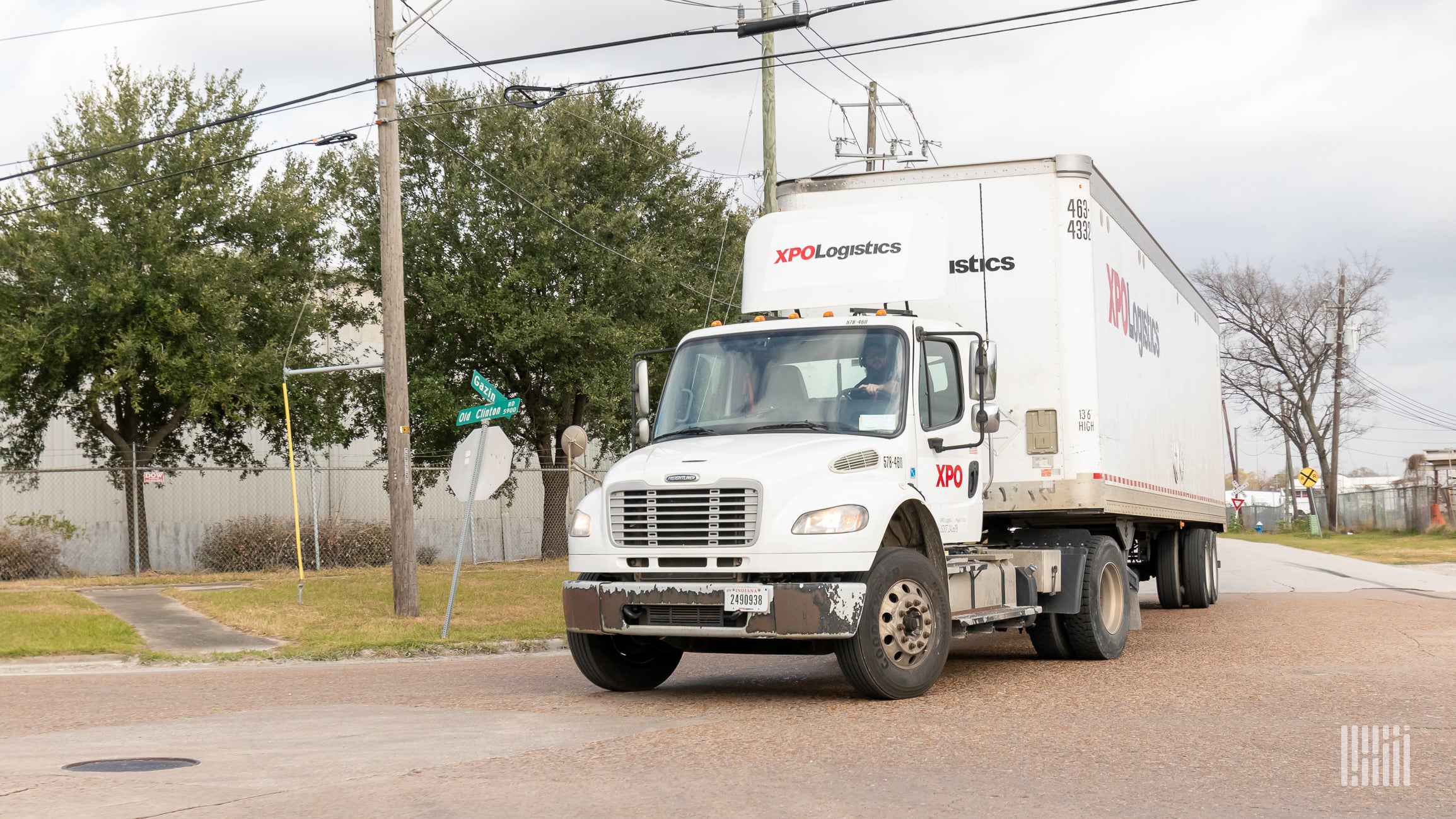 A white tractor-trailer with the logo of XPO Logistics