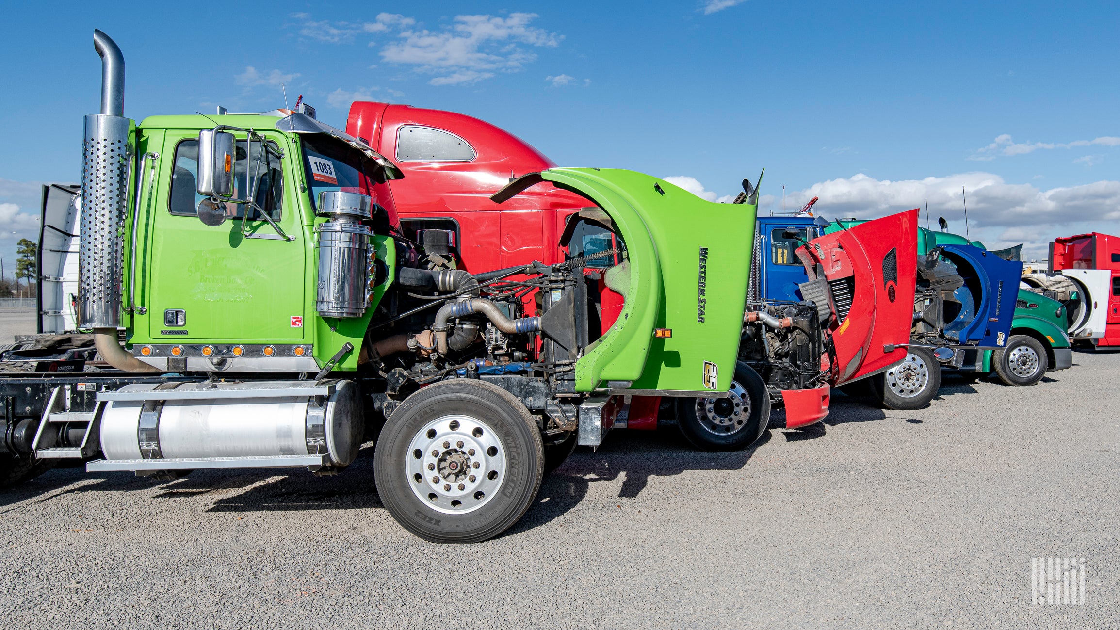 Truck with open hoods on auction lot