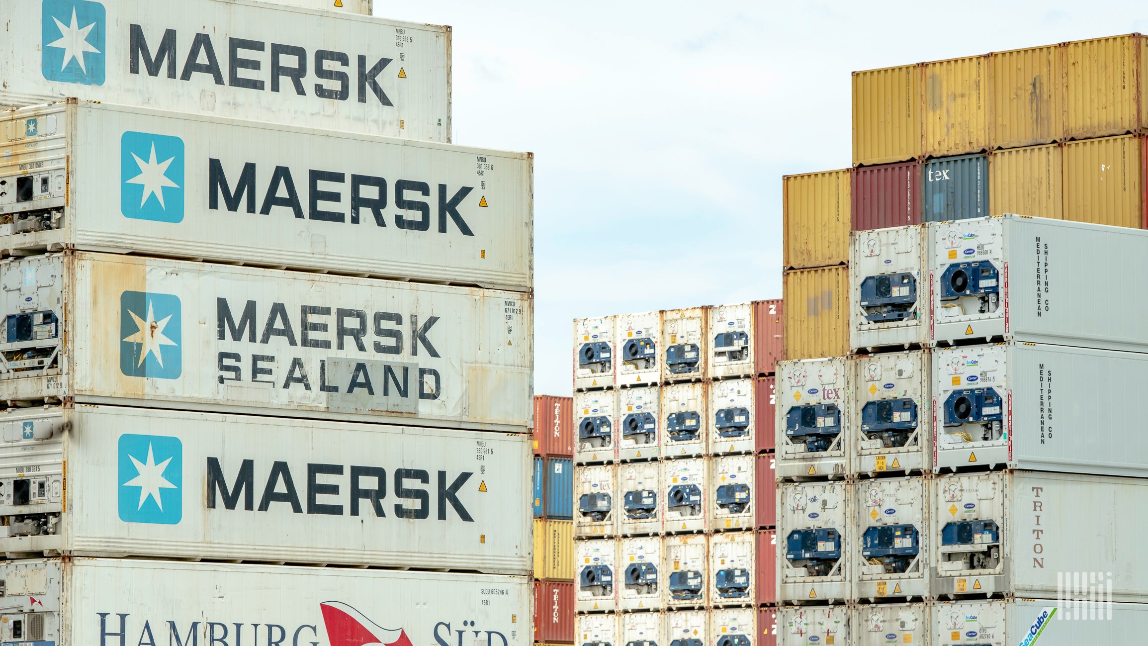 Stacks of refrigerated containers with Maersk and MSC logos on the side. The Port of Shanghai can't accommodate these containers anymore because of overcrowding.