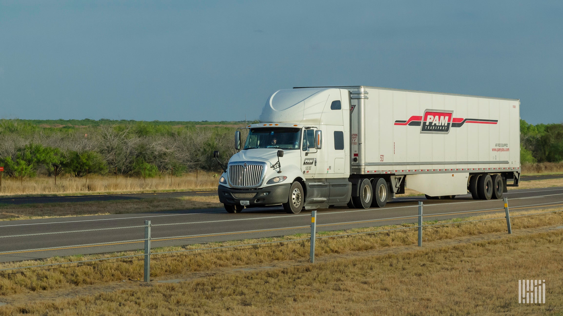 White tractor-trailer with the logo of P.A.M Transportation rig on highway