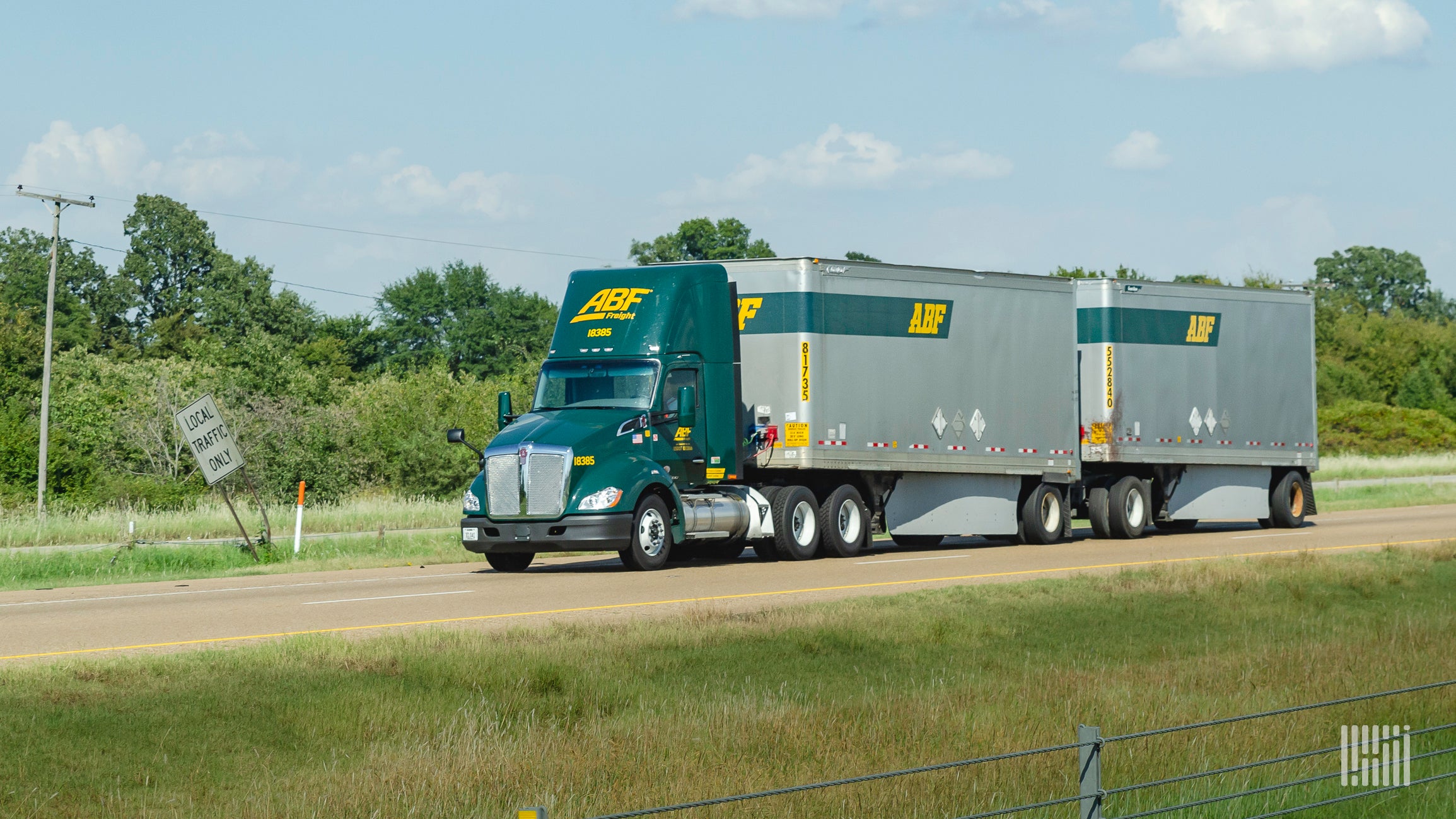 Green ABF Freight tractor pulling two ABF LTL trailers